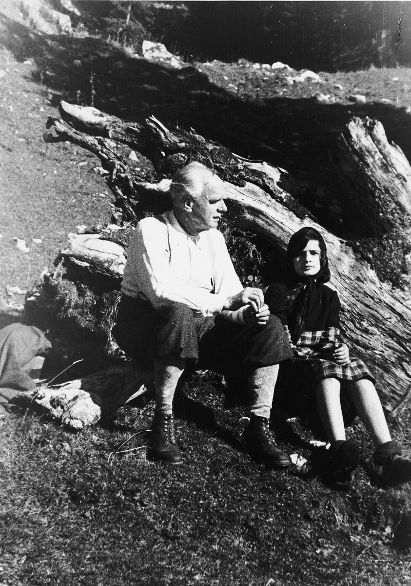 Sylvia Glaser rests on a large rock while hiking through the Bavarian Alps with her grandfather, Anton Fletcher.