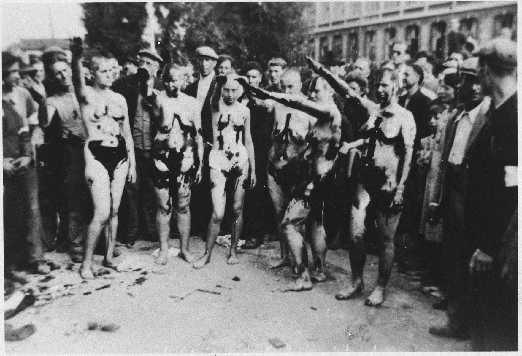 Belgian women who had collaborated with the Germans are shaved, tarred and feathered and forced to give a Nazi salute.