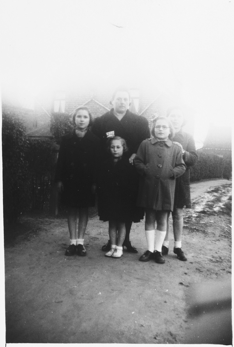 Four Jewish sisters who are living in hiding pose with their rescuer.

Pictured are Anna, Rebecca, Frederica, and Micheline Altenberg.