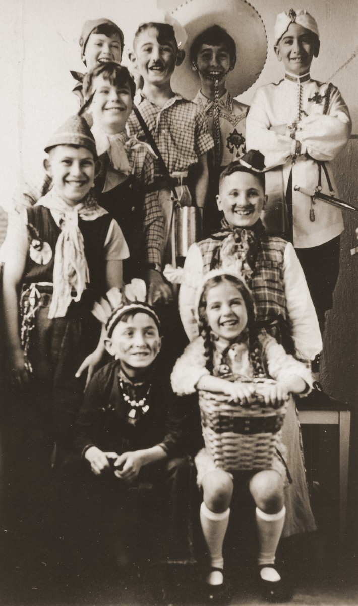 Group portrait of children dressed in costumes at a Purim party.

Among those pictured is Heinz Straus (upper right).