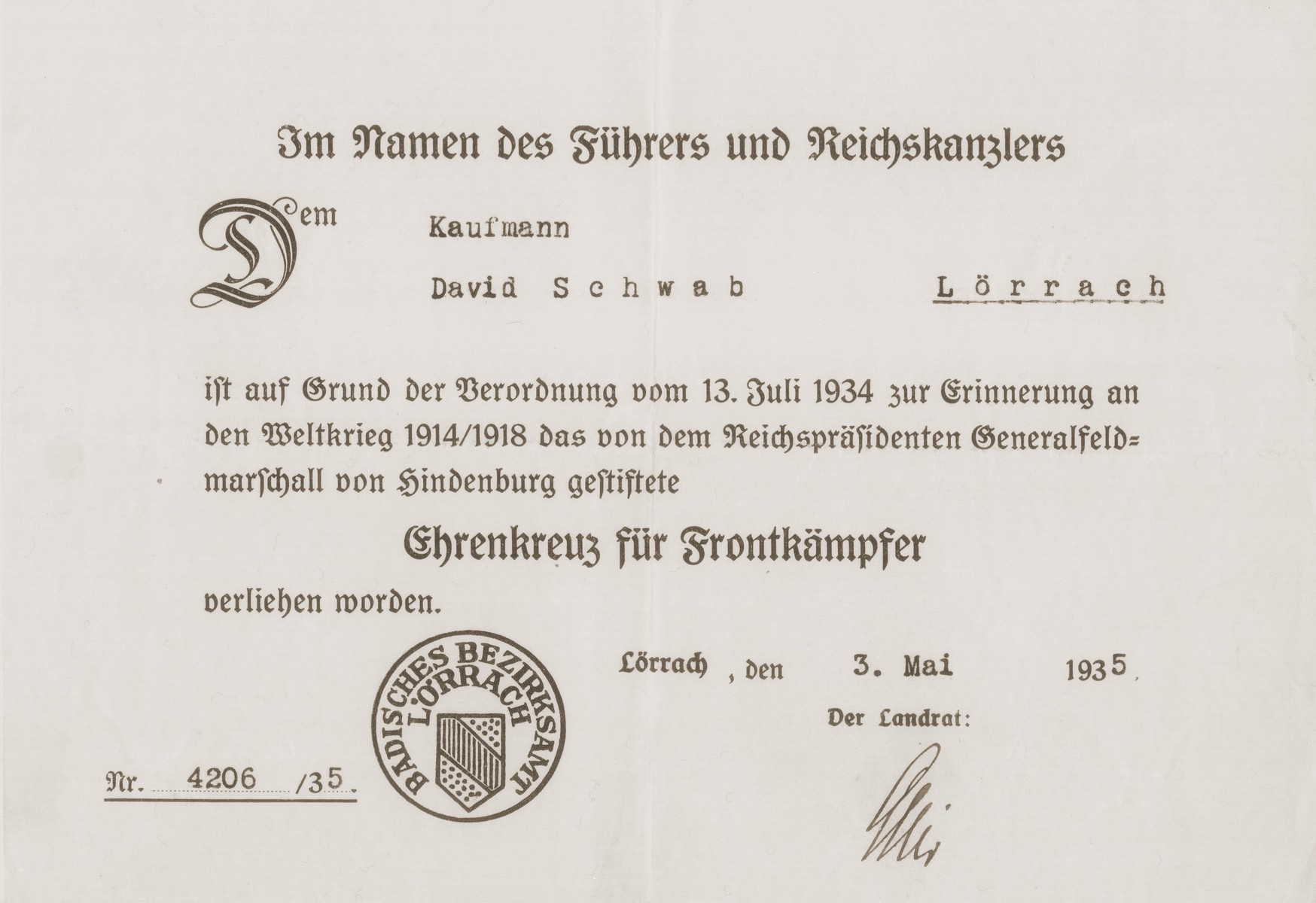 Certificate issued to the donor's father, David Schwab, by the Lorrach district office, for having earned a medal for his military service on the front lines during the [First] World War.  The certificate is issued "In the Name of the Leader and Chancellor."