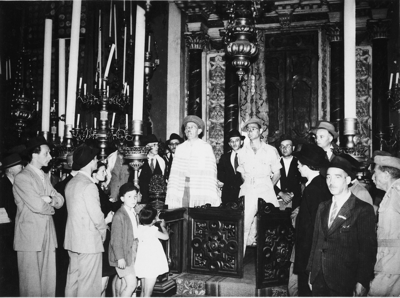 Jewish survivors gather in the Great German Synagogue in Venice.

Pictured to the left of the rabbi is Immanuel Ascarelli wearing his Jewish Brigade uniform.