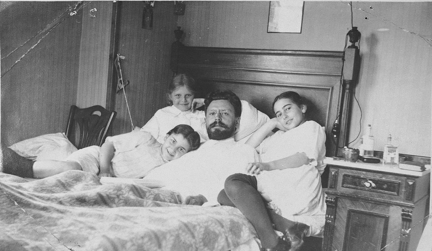 Sophie Libo's grandfather lies in bed surrounded by his daughter, Nina, and two nieces.