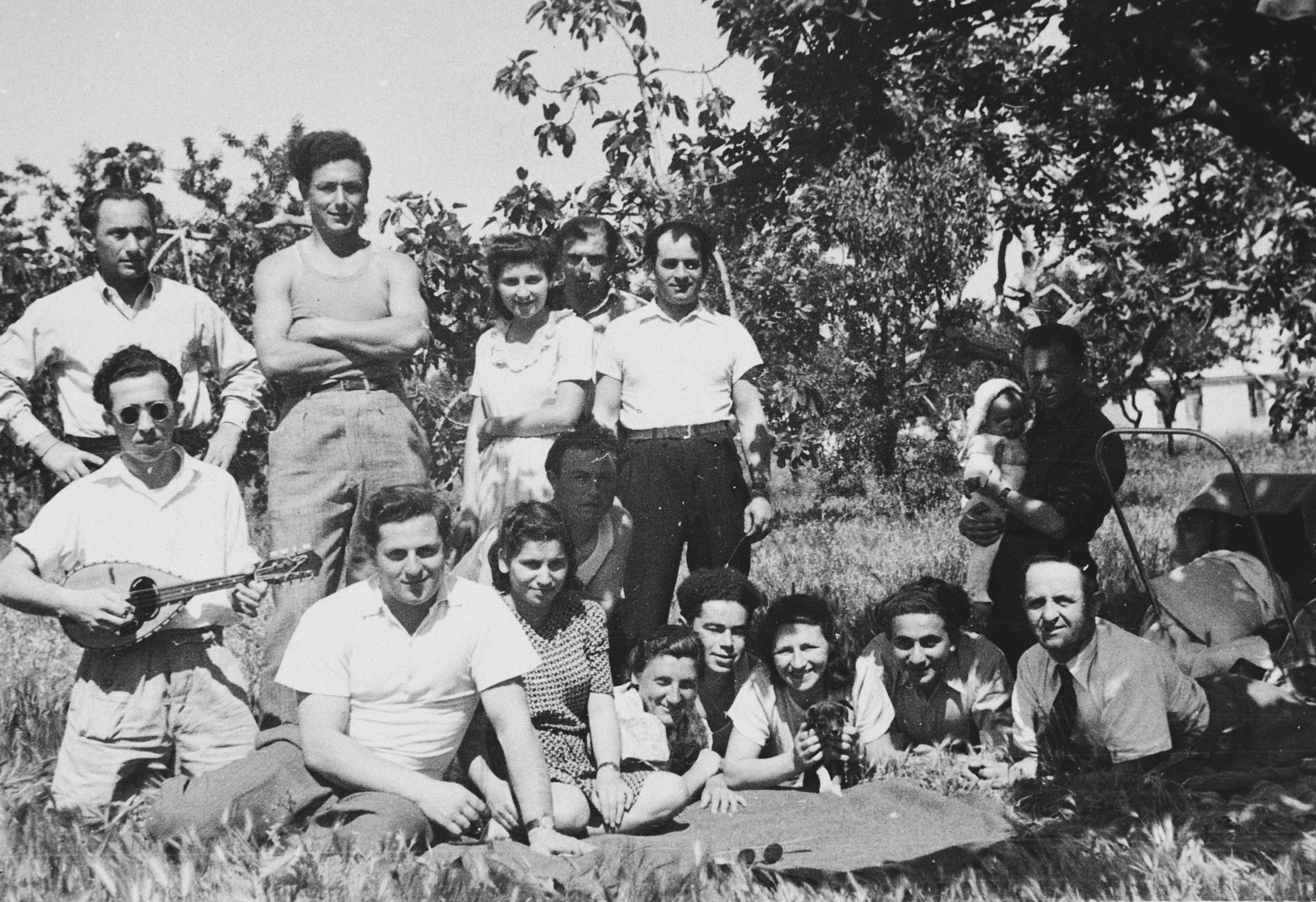 Jewish youth pose for a group portrait during an outdoor social gathering in the Bari displaced persons' camp.