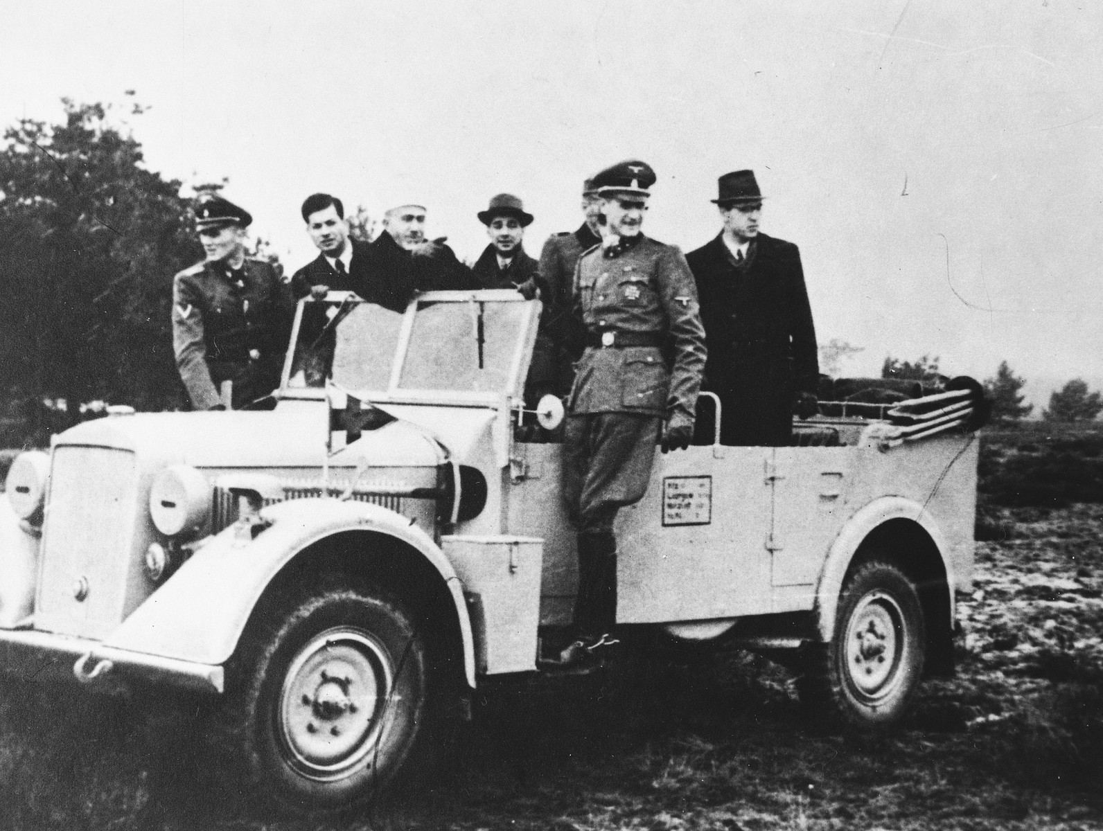Hajj Amin al-Husayni rides in an open jeep in the company of German SS and civilian officials during an official visit to Bosnia.