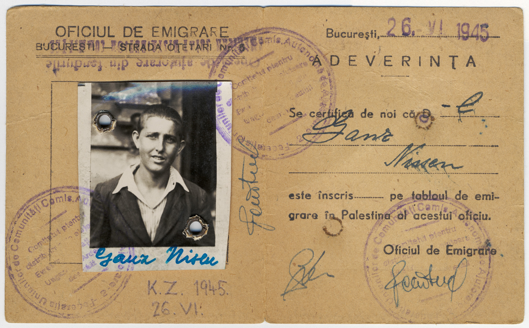 Certificate with attached photograph issued to Nisen  Ganz shortly after his liberation granting him permission to emigrate.