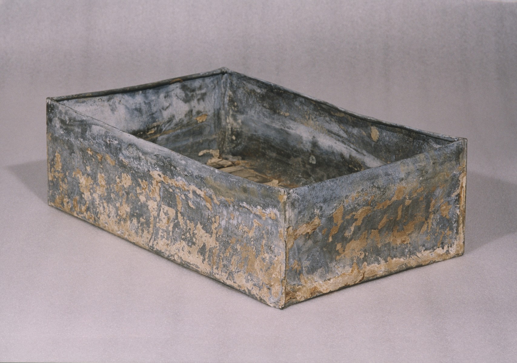 One of the ten metal boxes in which portions of the Ringelblum Oneg Shabbat archives were hidden and buried in the Warsaw ghetto.  The boxes are currently in the possession of the Jewish Historical Institute in Warsaw.  This view is of an open box without the lid.