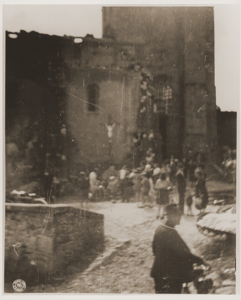 French civilians enter the ruins of a church in Oradour where SS troops killed the village's women and children during the massacre.