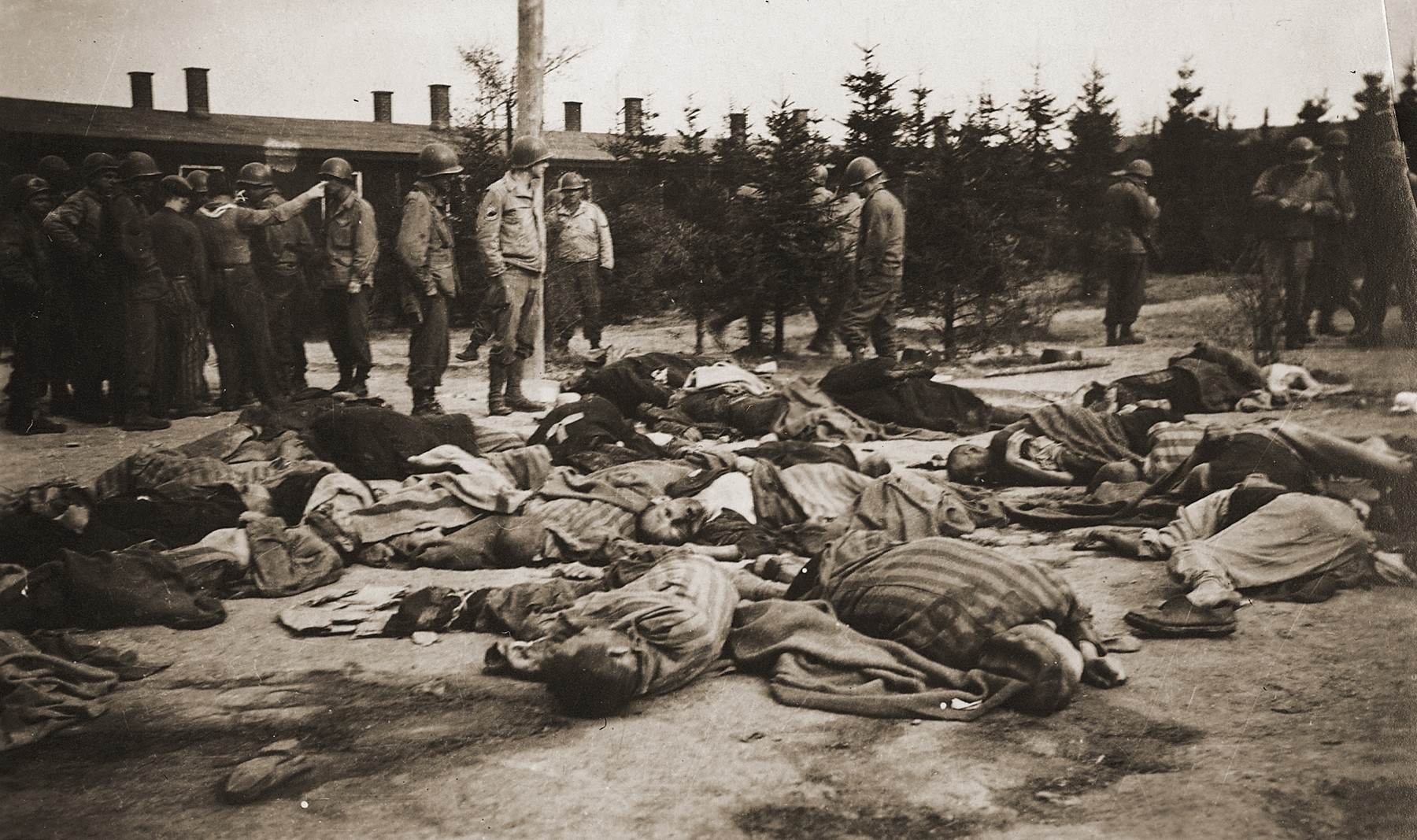 American soldiers view the bodies of prisoners shot by the SS during the evacuation of the Ohrdruf concentration camp.