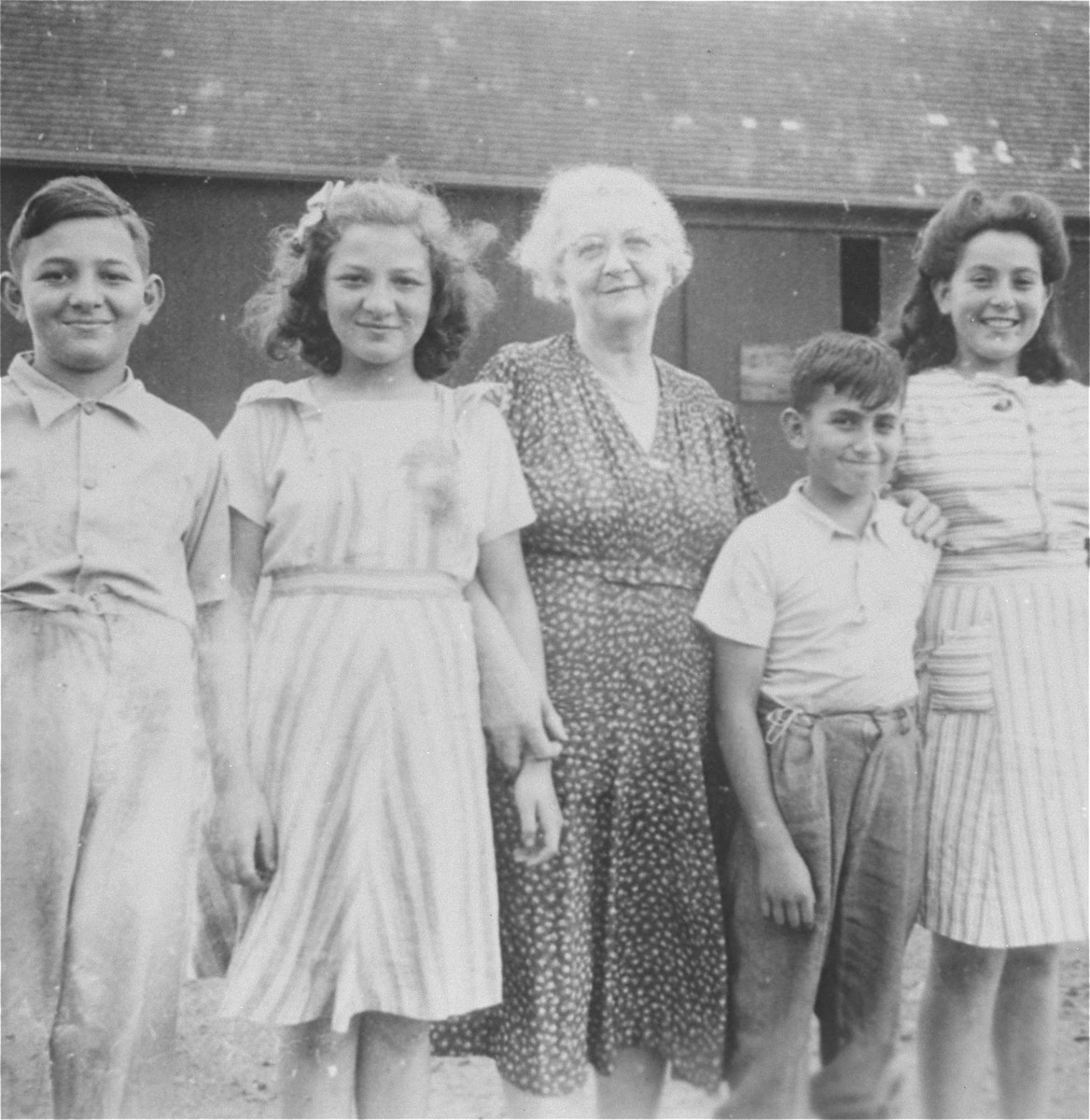 Group portrait of the Muller cousins on their farm in southern Ontario.

Pictured at the left are Henry and Alice Muller, and at the right, Agnes and George Muller.