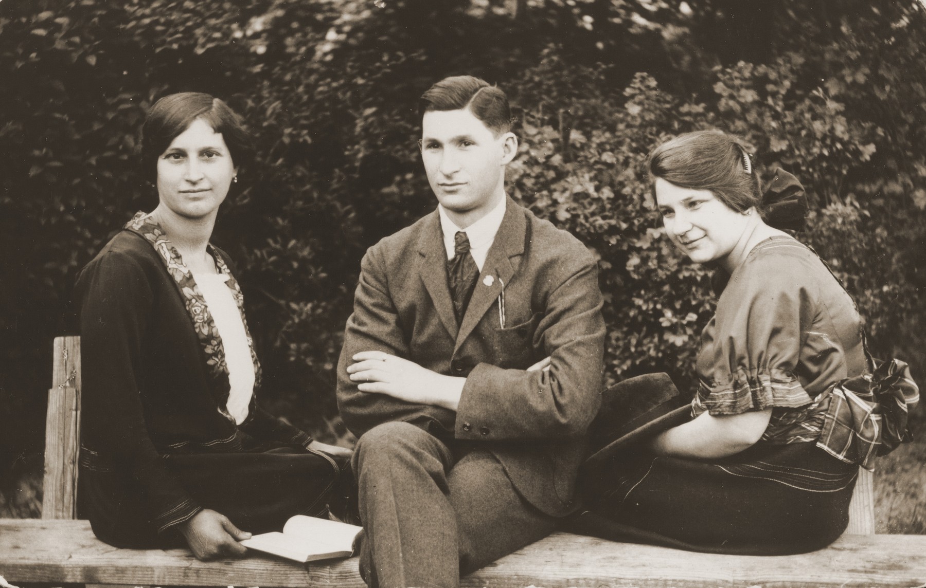 Group portrait of three Jewish siblings in Budapest.

Pictured from left to right are Piri, Andres and Boriska Kupfermann.  They are siblings of the donor's father, Beno Kupfermann.