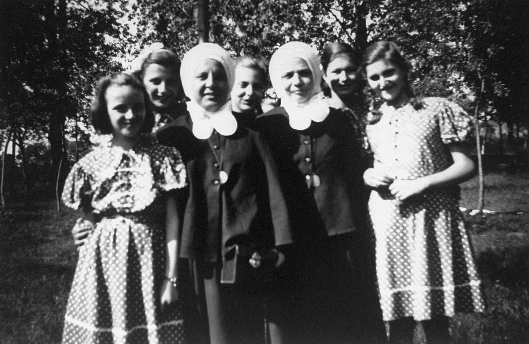 Dorottya Dezsoefi (first row, right) and her twin sister Ida Marianne (second row, center) pose with two nuns outside of the convent school where they were hidden for two years.  

Sister Gabriella is in the first row, beside Dorottya.