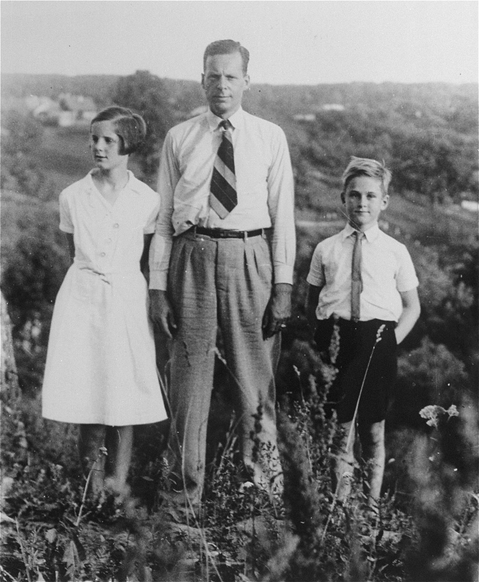 Honorary Dutch Consul Jan Zwartendijk with his son Jan and daughter in Kovno.

Jan Zwartendijk (1896-1976) arrived in Kovno in 1938 as the Dutch representative of Philips Electric in Lithuania.  Soon after the fall of Holland to Hitler's forces on 10 May 1940, however, Zwartendijk was named the honorary Dutch consul by ambassador LPJ de Decker in Riga, Latvia, who sacked the official consul for having pro-Nazi sentiments.  This change came at roughly the same time as the Soviet occupation of Lithuania in June 1940.  Zwartendijk was then approached in the third week of July 1940 by Nathan Gutwirth, a Dutch national and young yeshiva student in Tels, Lithuania, who he had come to know through their common interest in soccer. Gutwirth requested a transit visa to Curacao, which Zwartendijk was denied permission to give.  Zwartendijk then appealed to de Decker for help and the ambassador sent him a document stating that no visa was necessary for travel to Curacao, and that landing was permitted solely at the discretion of the island's governor.  De Decker suggested that Zwartendijk simply strike out the part about the governor's authority and write into Gutwirth's passport an official statement that he was travelling to Curacao.  Zwartendijk followed this course and within hours Gutwirth had spread word about the 'pseudo visas' among the thousands of Polish-Jewish refugees in Kovno, who subsequently flooded Zwartendijk's office seeking 'Curacao visas'.  These 'visas' were then used by refugees to procure Japanese transit visas from Sugihara through the USSR.  It is estimated that by the time the Dutch consulate was closed at the beginning of August 1940, Zwartendijk had written between 1200 and 1400 life saving 'visas'.