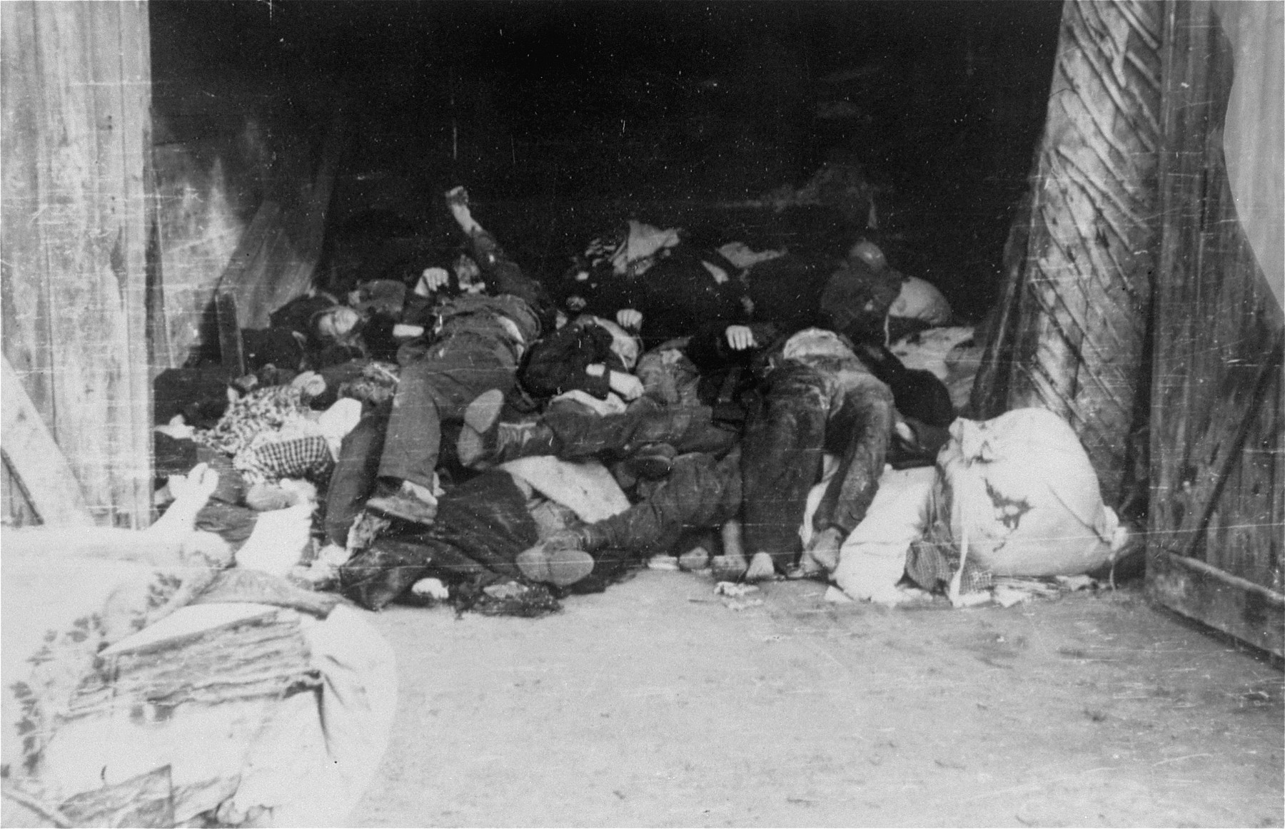 The corpses of Jews are piled up in a barn in the Deblin Irena ghetto.

The corpses of those who were murdered in the ghetto during the expulsion Aktion to Sobibor were transported by cart to the Jewish cemetery in Bobrowniki.  [Source: Yad Vashem research notes.]