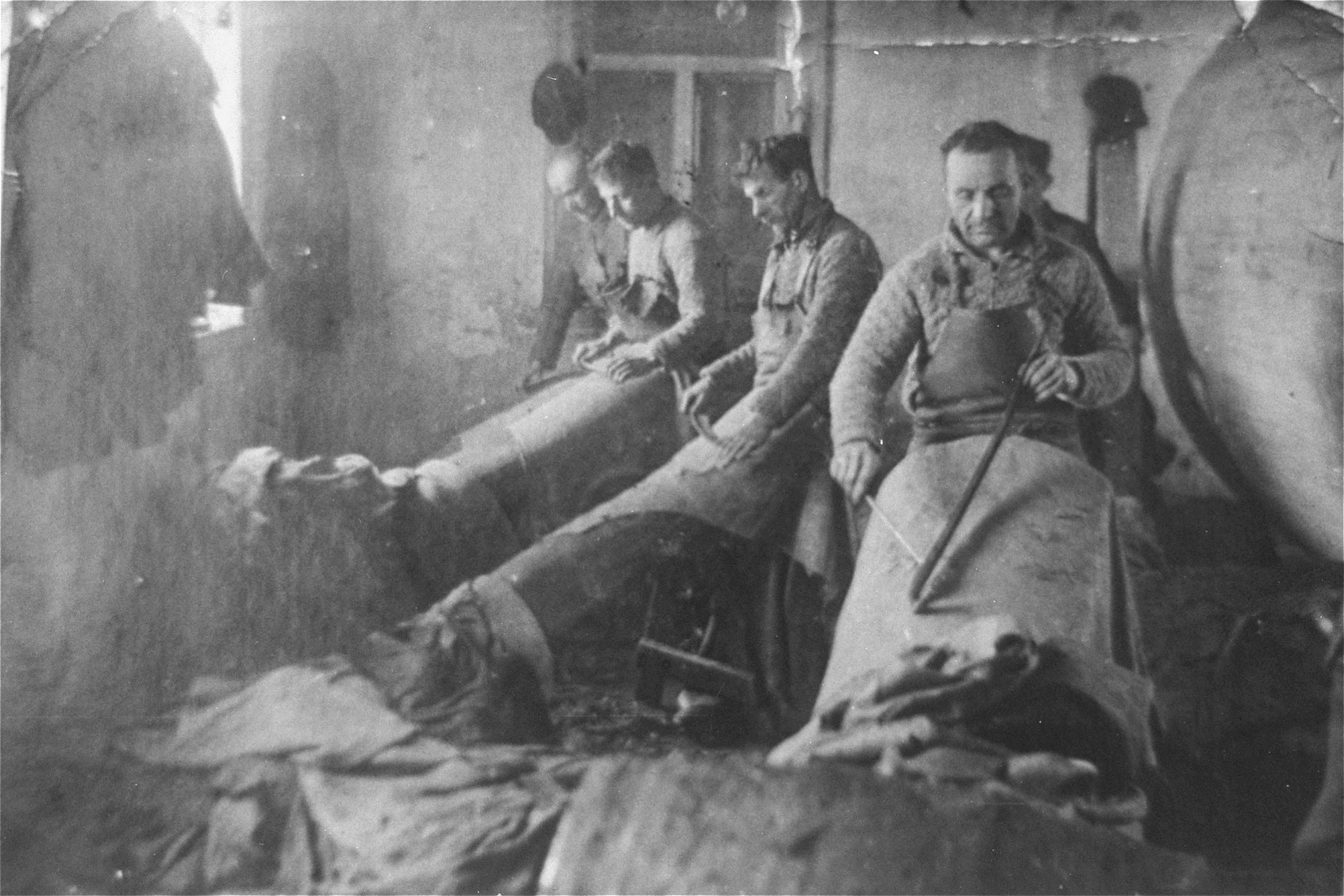 Jewish men working in a tanning workshop in the Glubokoye ghetto.