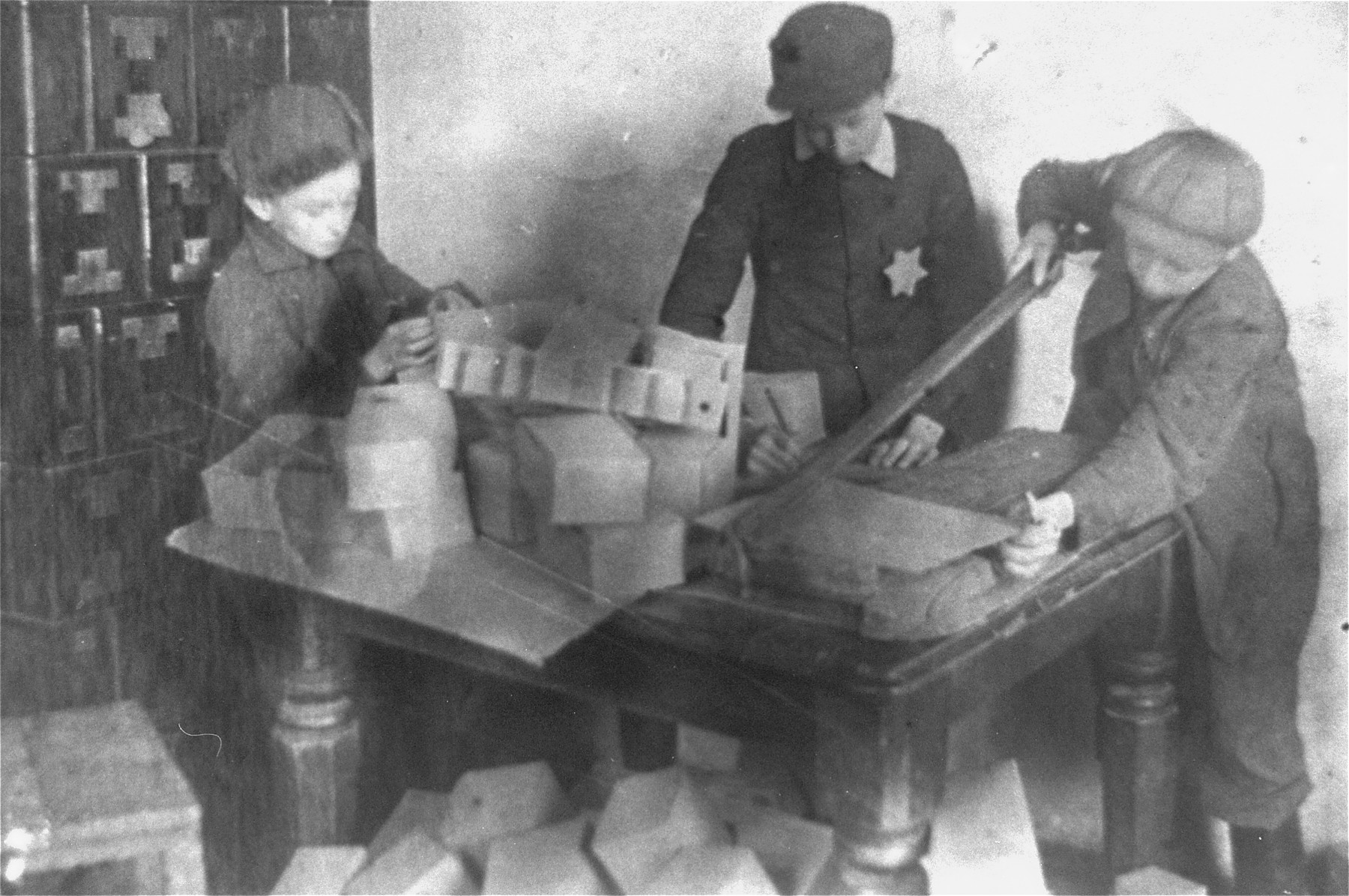 Jewish children making boxes in the Glubokoye ghetto.