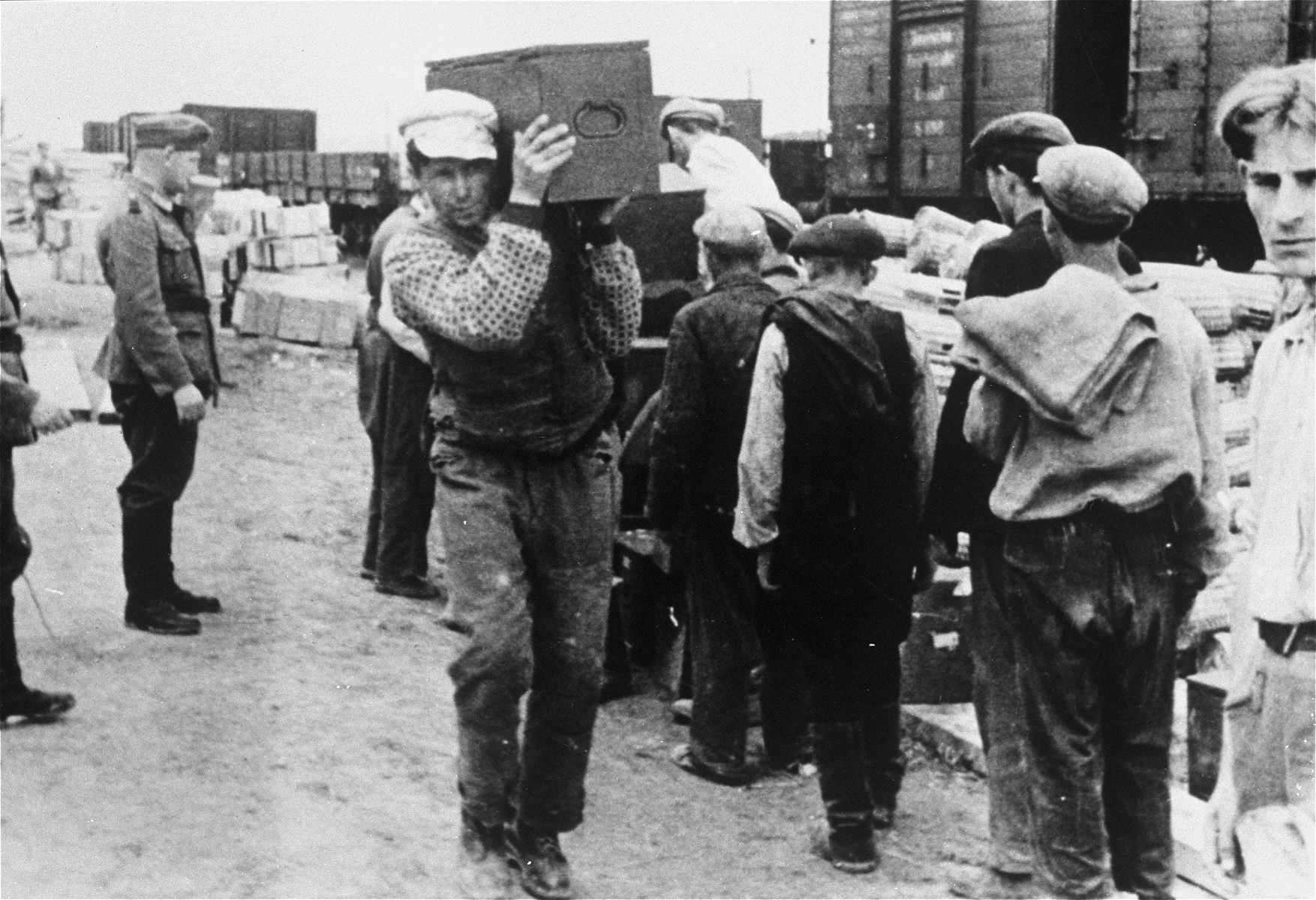 Jews at forced labor unloading artillery munitions at a Wehrmacht supply depot.