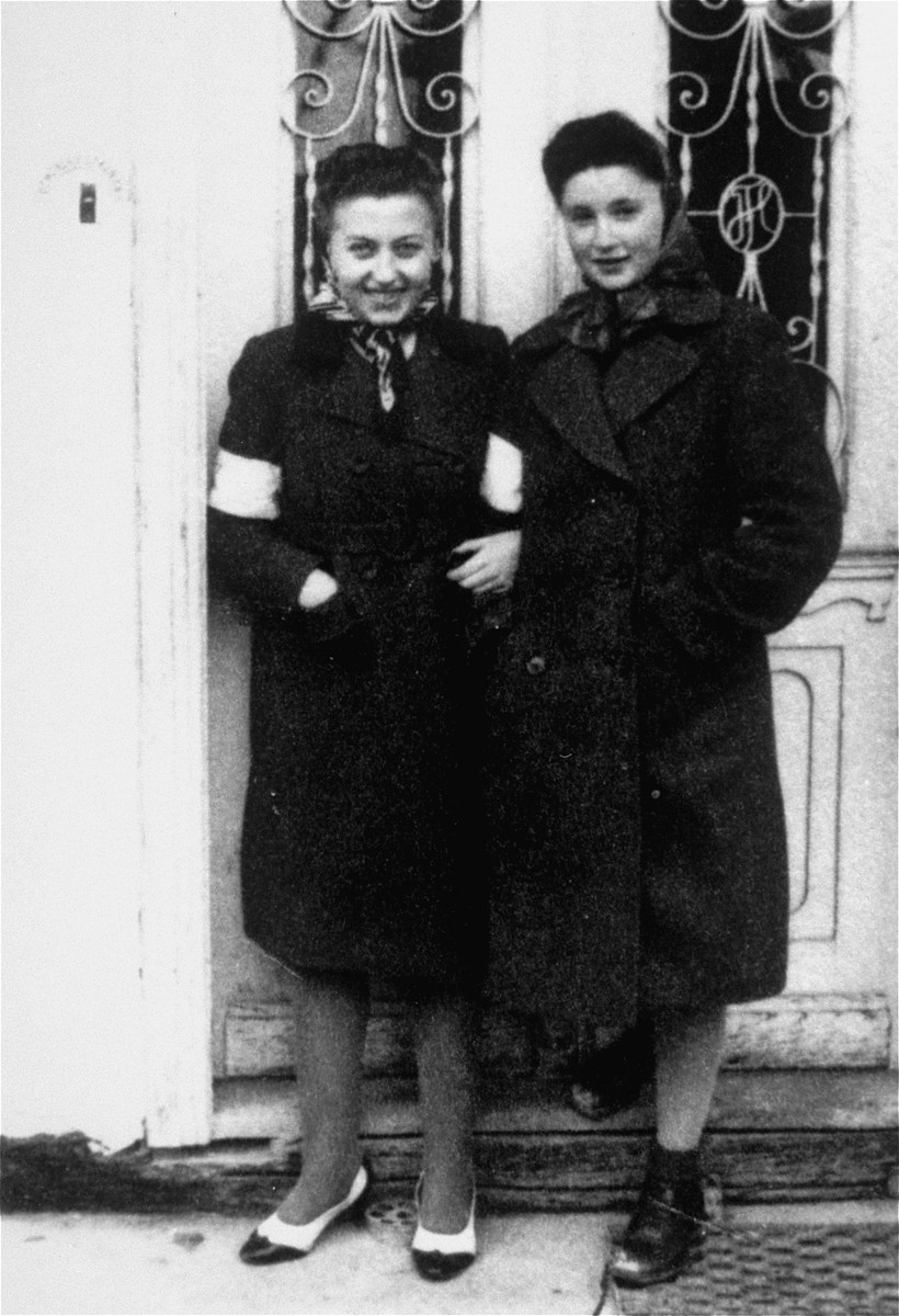 Two young Jewish women pose wearing armbands in front of the Fleischer home in the Borislaw ghetto.

Pictured are Nina Fleischer and Fania Begleiter. Fania perished during the war.