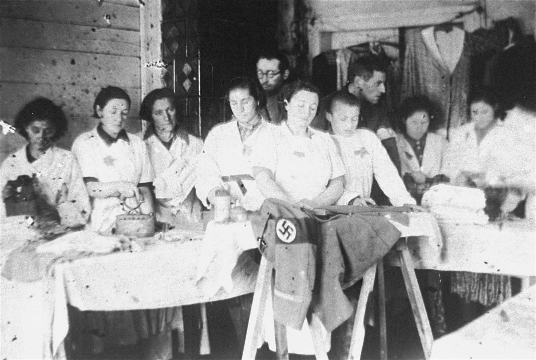 Jewish women press Nazi military uniforms in a workshop in the Glubokoye ghetto.