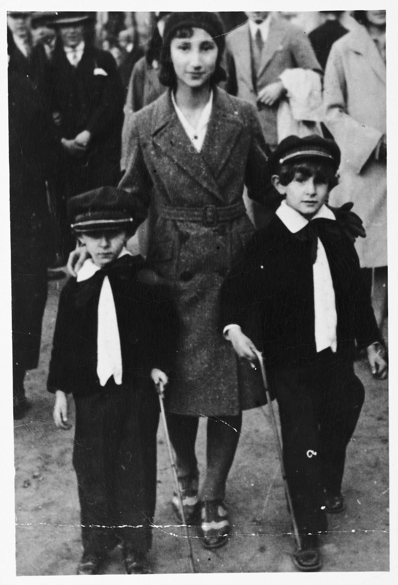 Three Jewish siblings pose on a street in Krakow.

Pictured are Mela Rosner (the wife of donor Stanley Zanger) with her brothers Velvel (left) and Samek (right).