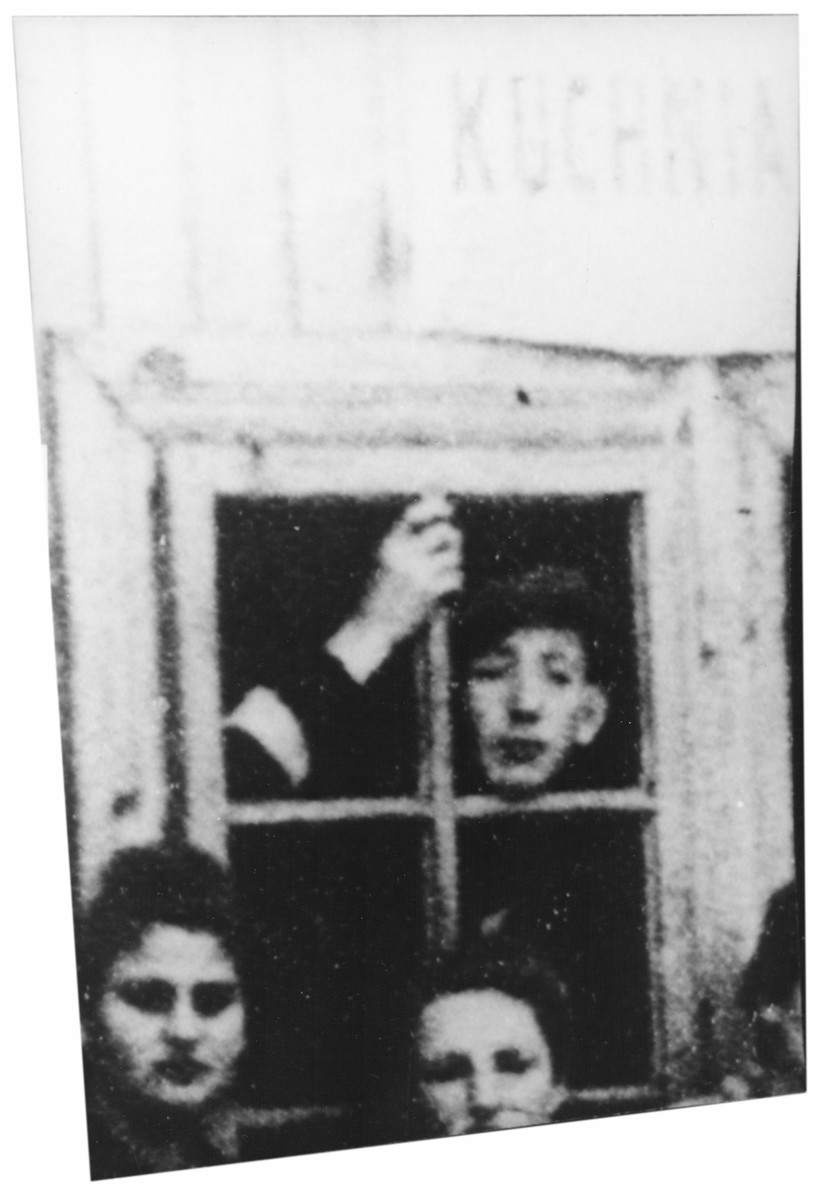A Jewish youth peers out the window of a soup kitchen in the Cmielow ghetto.

Pictured at the window is Toivia Grunbaum (now Teddy Greenbaum).