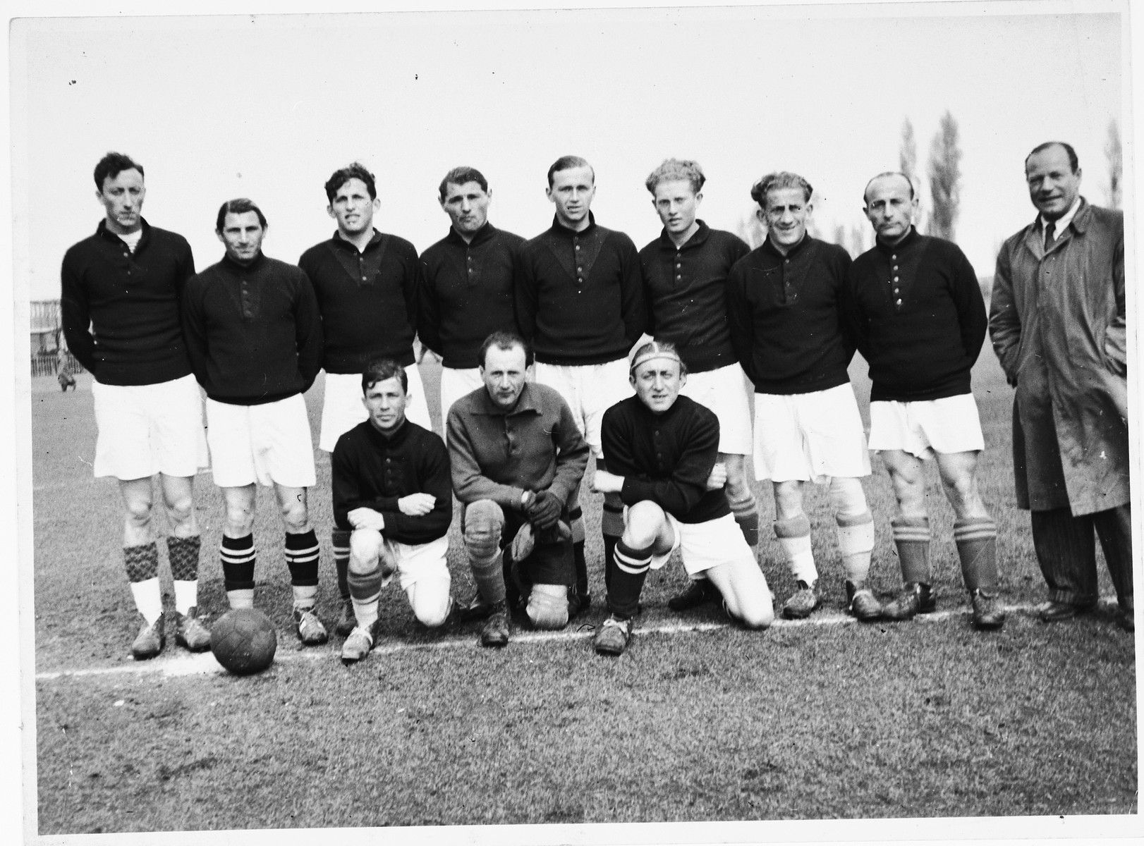 Group portrait of the members of the Schlachtensee displaced persons camp soccer team.

Among those pictured are Moritz Sachs (standing third from the left), Jacob (Yanek) Czarny (later Jack Charney, fourth from the left); and Simon Krumhloz (the manager, standing on the right in the coat and tie).