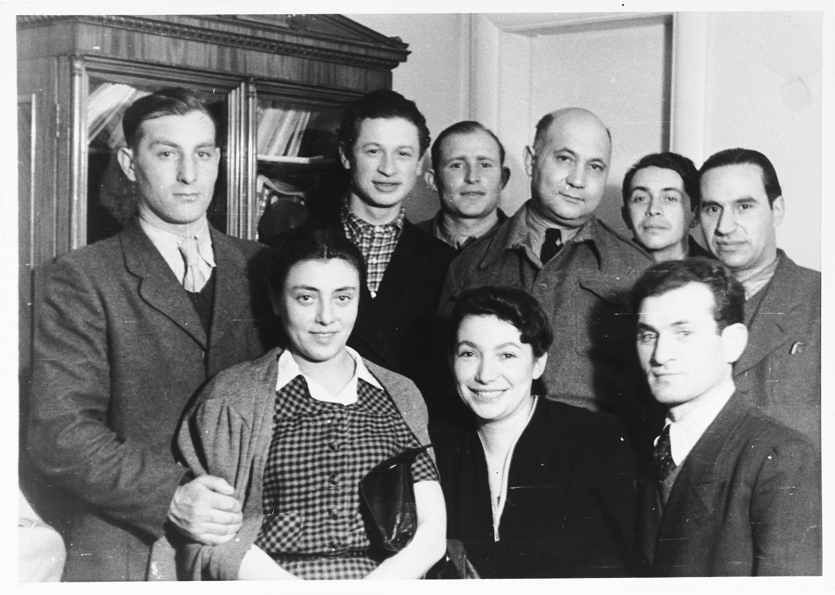 UNRRA camp director Harold Fishbein poses with a group of Jewish DPs in an apartment in the Schlachtensee displaced persons camp.

Harold Fishbein is pictured in the back row, third from the right.