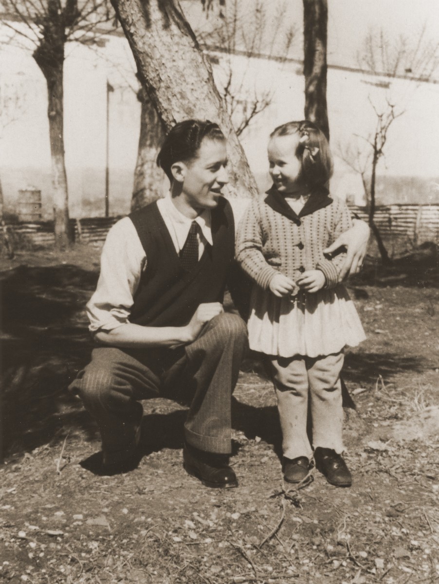 A Jewish DP child poses outside with a young man in the Cremona displaced persons camp.

Pictured is Masha Leikach.