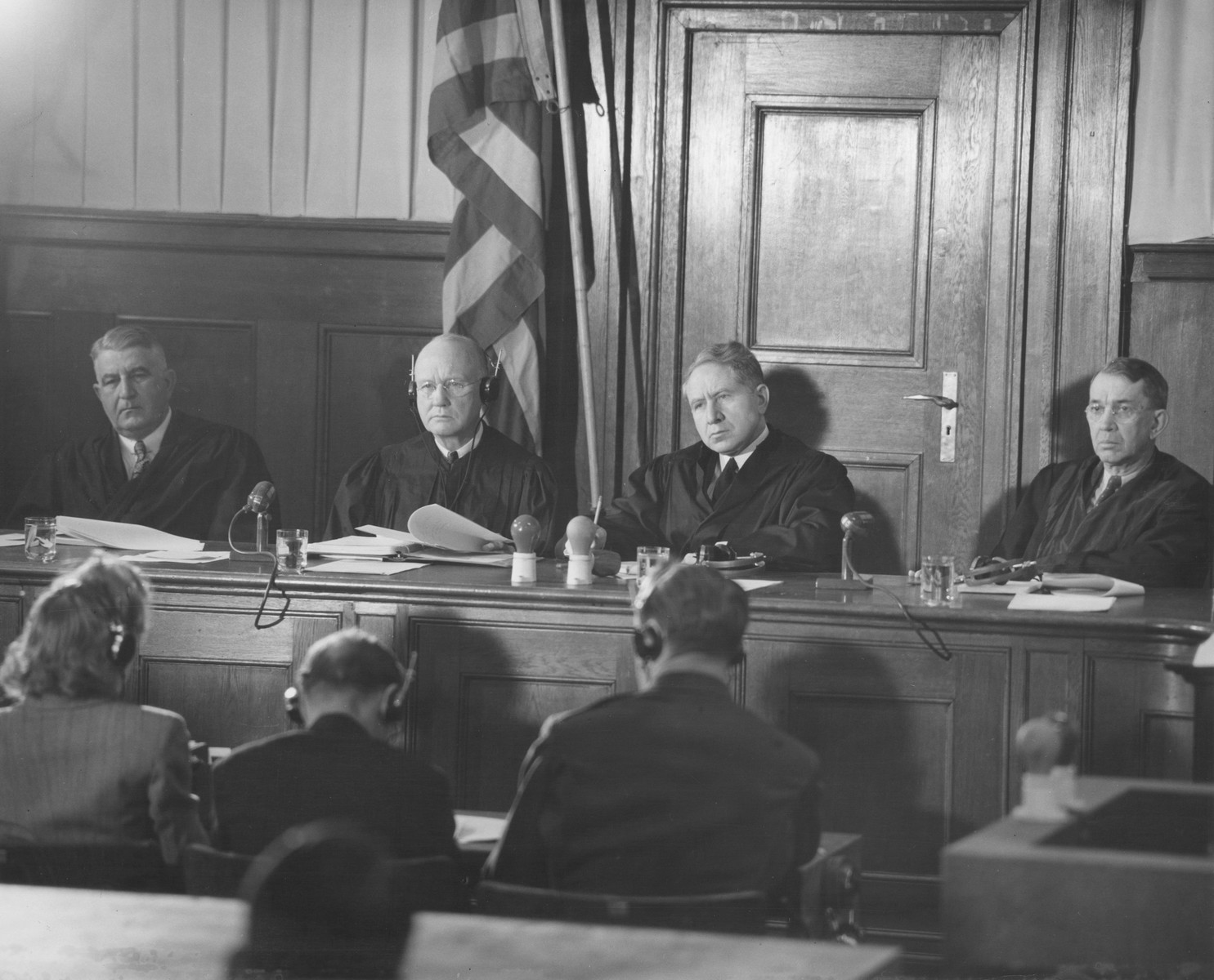 The judges of Military Tribunal II at a session of the Milch Trial.  

Pictured from left to right are F. Donald Phillips, Robert M. Toms, Michael A. Musmanno, and John J. Speight.