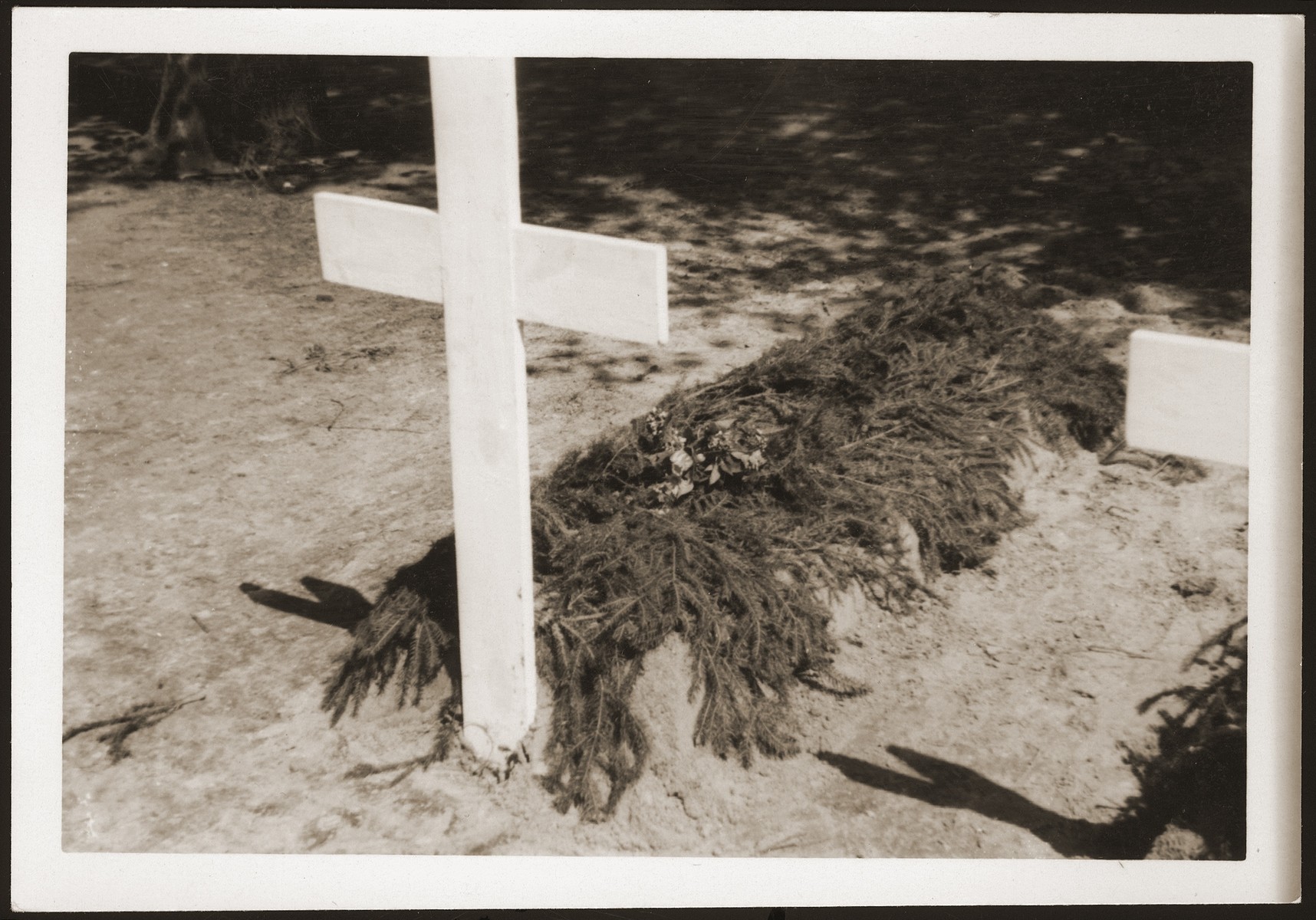 One of 200 graves dug by the people of Ludwigslust on the palace grounds of the Archduke of Mecklenburg, where they have been forced by U.S. troops to bury the bodies of prisoners killed in the Woebbelin concentration camp.
