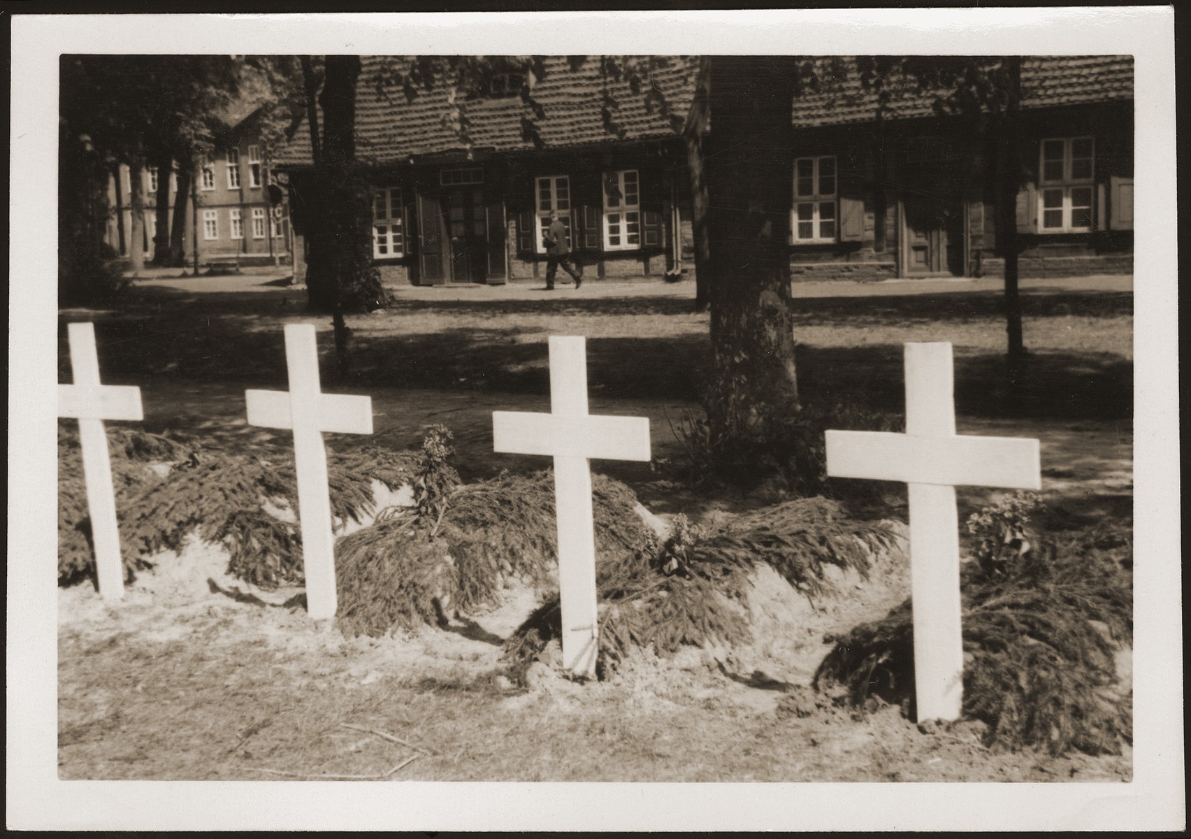 Graves dug by the people of Ludwigslust on the palace grounds of the Archduke of Mecklenburg, where they have been forced by U.S. troops to bury the bodies of prisoners killed in the Woebbelin concentration camp.