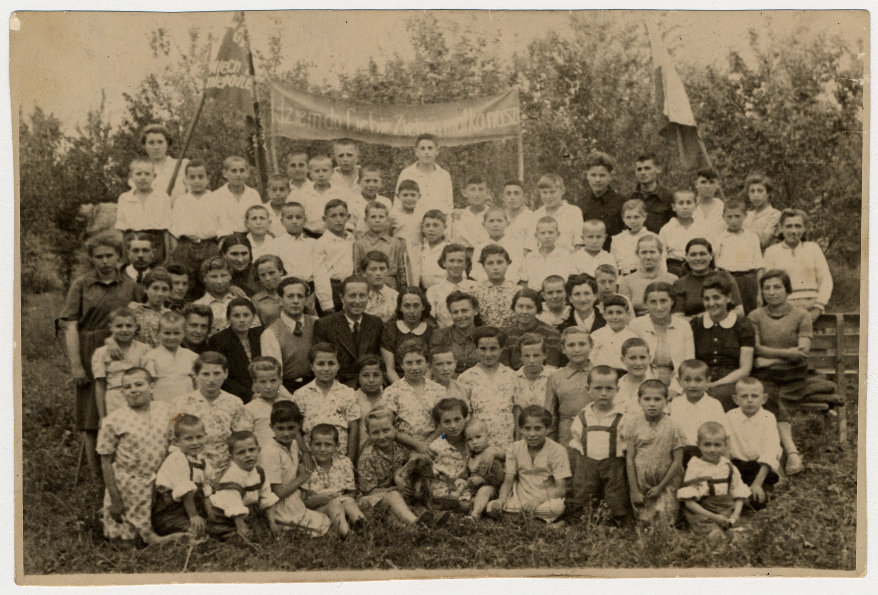 Group portrait of Polish-Jewish refugee children in an orphanage at the Pahta Abak-Kolhoz farm outside Andizhan, Uzbekistan shortly before they were repatriated to Poland.

Among those pictured is Irena Ceder (seated in front in a white dress, fifth from the right).