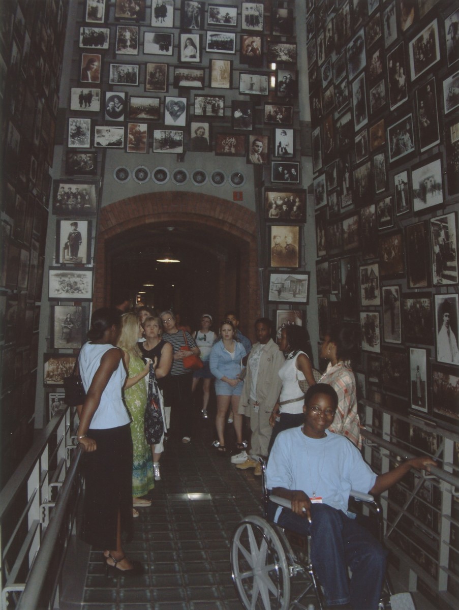 A group of students views the Tower of Faces (Yaffa Eliach Shtetl Collection) in the permanent exhibition of the U.S. Holocaust Memorial Museum.