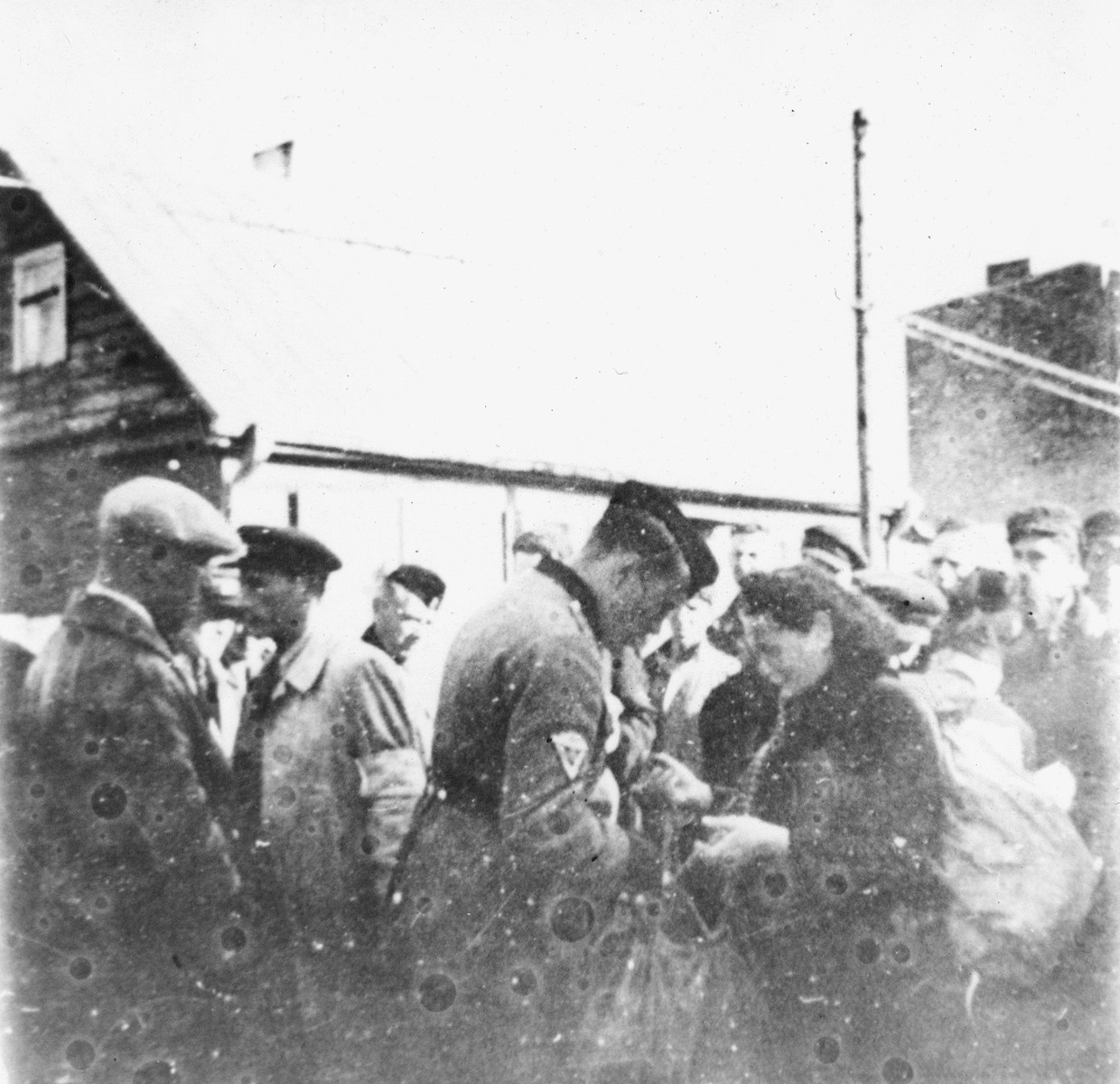Kovno workers are searched by ghetto police at the Krisciukaicio Street entrance upon their return from forced labor outside the ghetto.