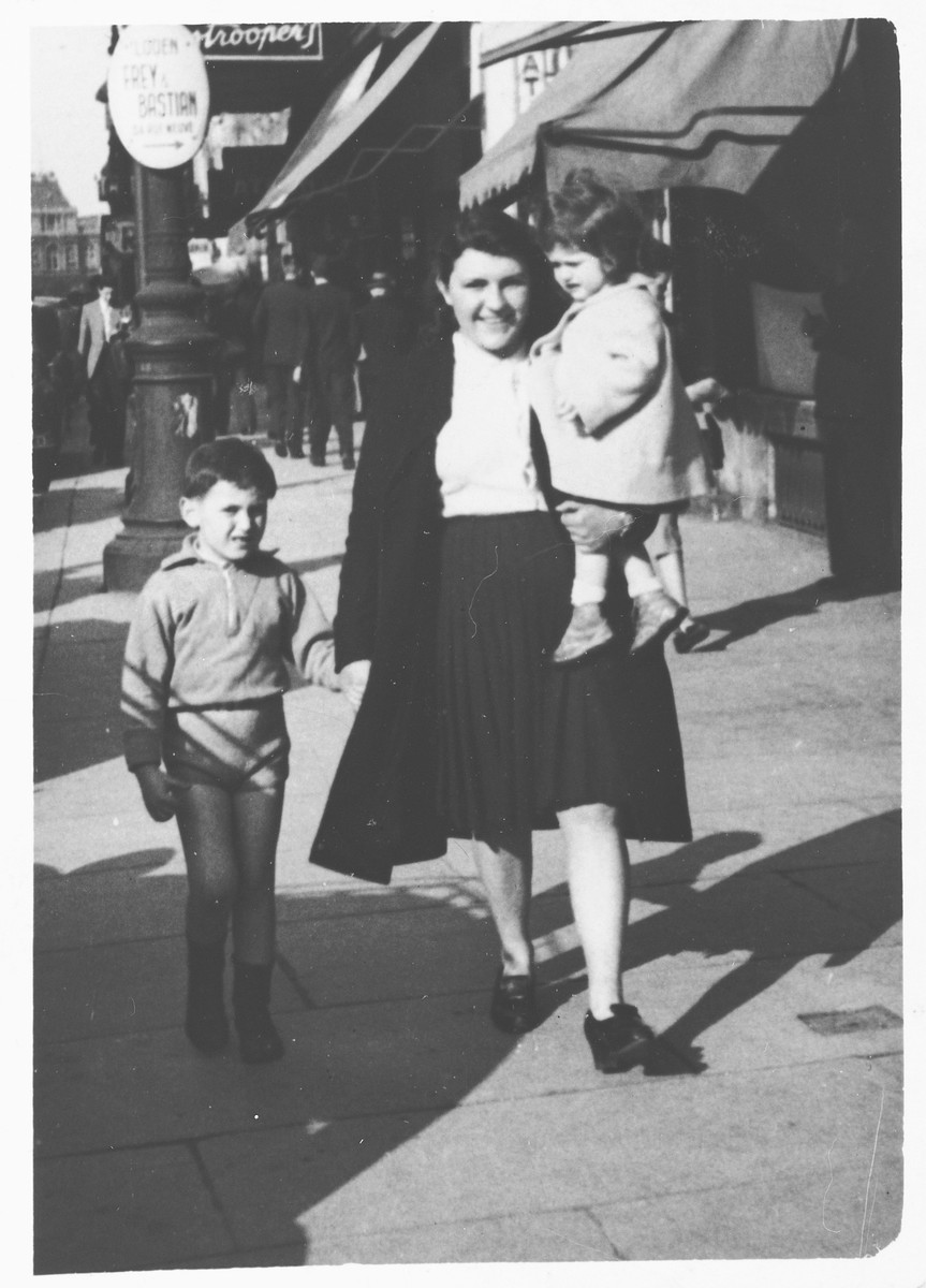 Georges and Myriam Abramowicz go for a walk with their maid down a street in Brussels.