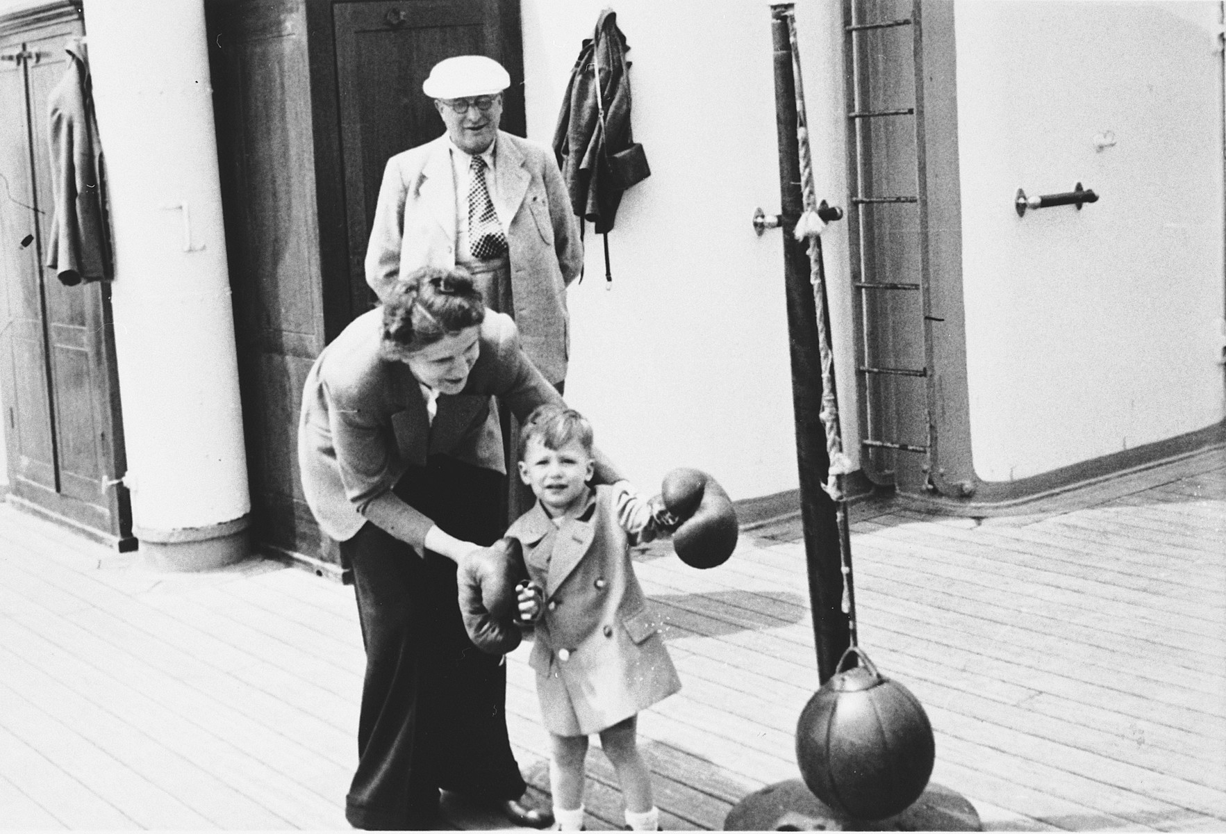 Klara Chraplewski helps her young son play tether ball on board the St. Louis.