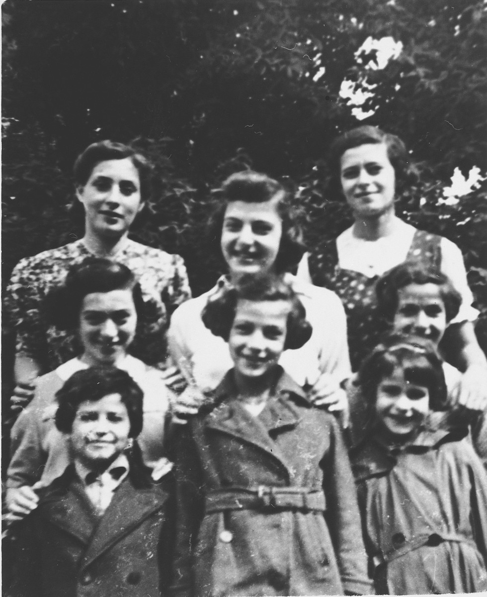 Portrait of eight Jewish refugee girls in the garden of the children's home in Zuen.

Pictured include Rosalie Blau (now Johnson), Toni Rosenblatt, Ruth Rosenblatt, Regina Rosenblatt, Lotte Nussbaum, Inge Joseph and Edith Goldapper (now Rosenthal).