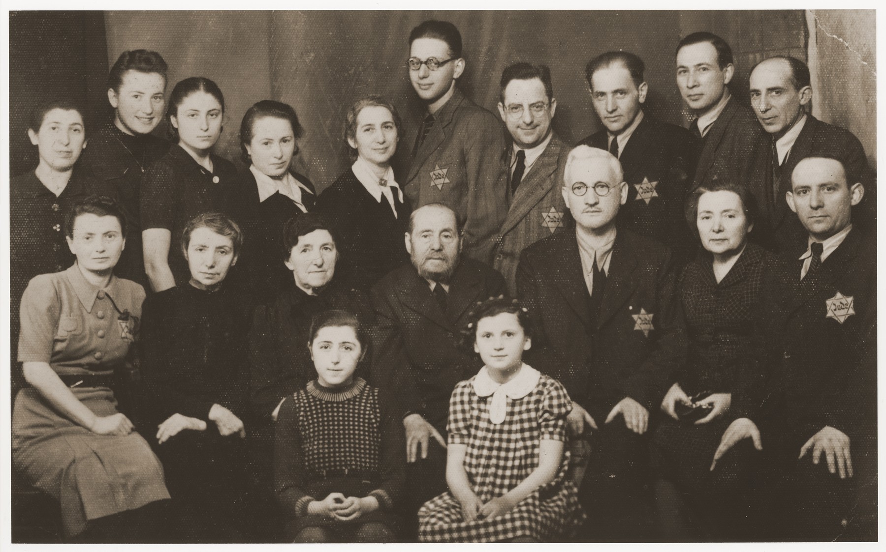 Group portrait of members of the Buchwajc and Laskier families in the Bedzin ghetto.  

Among those pictured is Hala Buchwajc (top row, second from the left), Chana Laskier (top row, fifth from the left), Yehuda Laskier (top row, sixth from the left, Chana's son), Michal Laskier (top row, seventh from the left, Chana's husband), Ida Buchwajc (front row, second from the right, Hala's mother), and Pinkus Buchwajc (third from the right, Hala's father). The Laskiers survived the war in the Tittmoning international internment camp.  They were able to leave Bedzin on South American passports secured for them by their relative, Alfred Schwartzbaum, in Switzerland.