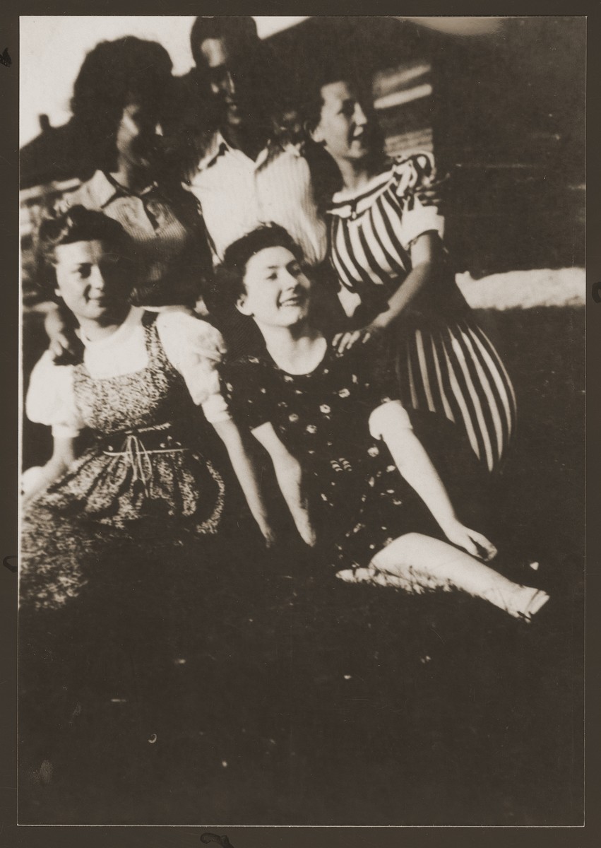 Group portrait of Jewish youth in the Dabrowa ghetto who are members of the Gordonia Zionist youth movement.

Standing from left to right are: Simka Spokojna, Zygmunt Kalmanowicz and Bronka Rubinsztajn.  Seated are Bela Krystal (left) and Shewa Szeps (right, the donor).