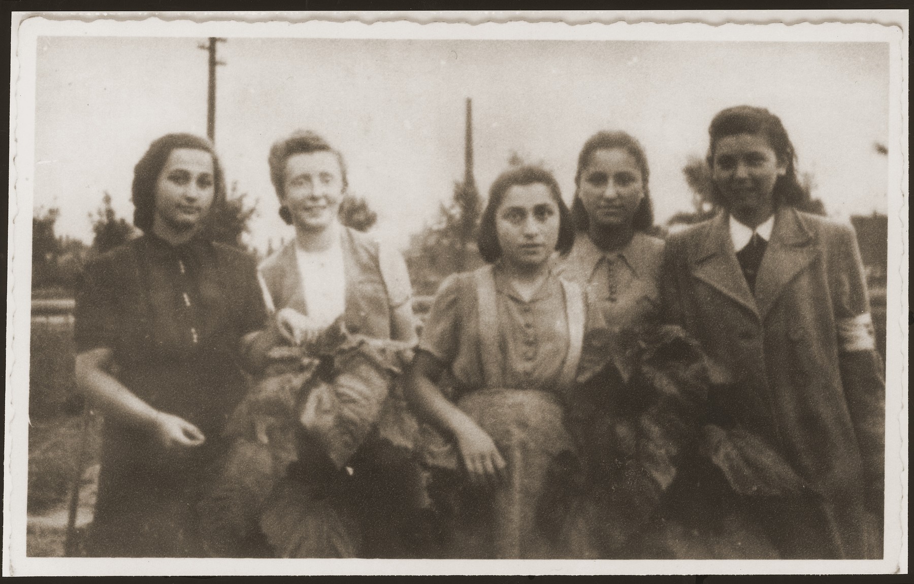 Young women pose together in a vegetable garden in Sosnowiec prior to the establishment of the ghetto.

Pictured from left to right are: Mania Lenczner (now Shafer), Hessa Weingarten (she did not survive the war), Fredzia Zajac (now Schweitzer), Lorka Posner (now Gleitman) and Gucia Adler.