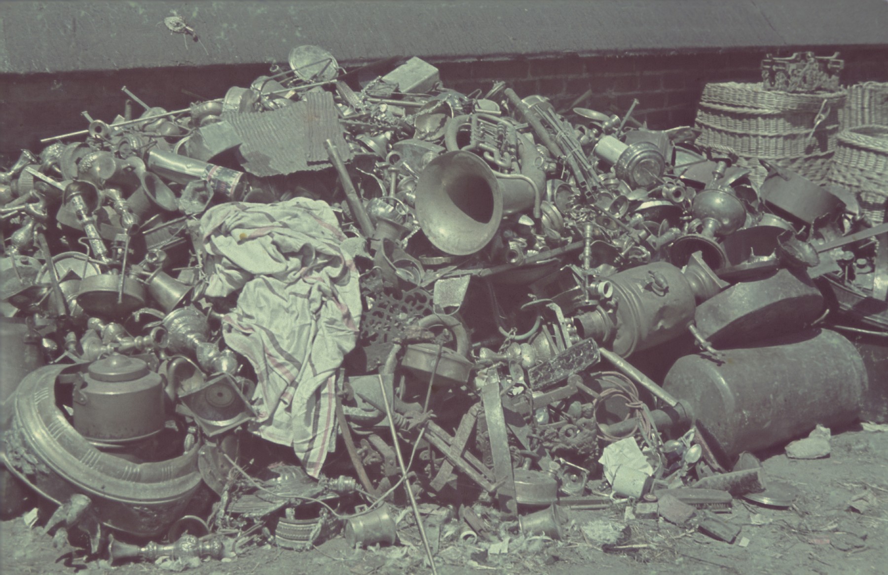 Pile of discarded personal items and scrap metal in the Pabianice labor camp/storage facility.

Original German caption: "Pabianice, Judenlager" (Jewish camp), #30.