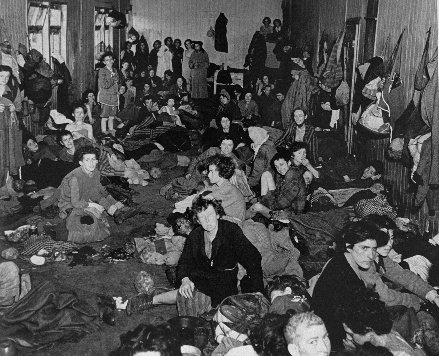 Female survivors in the "Gypsy barracks" after liberation. 

The original caption reads: "A view of the interior of one of the huts."