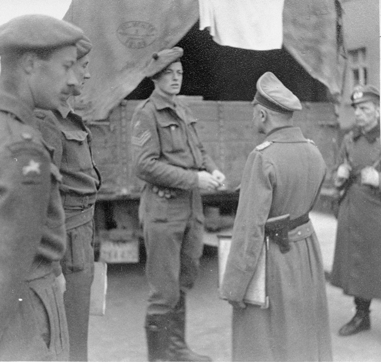 British soldiers accepting the surrender of a German officer in Bergen-Belsen.