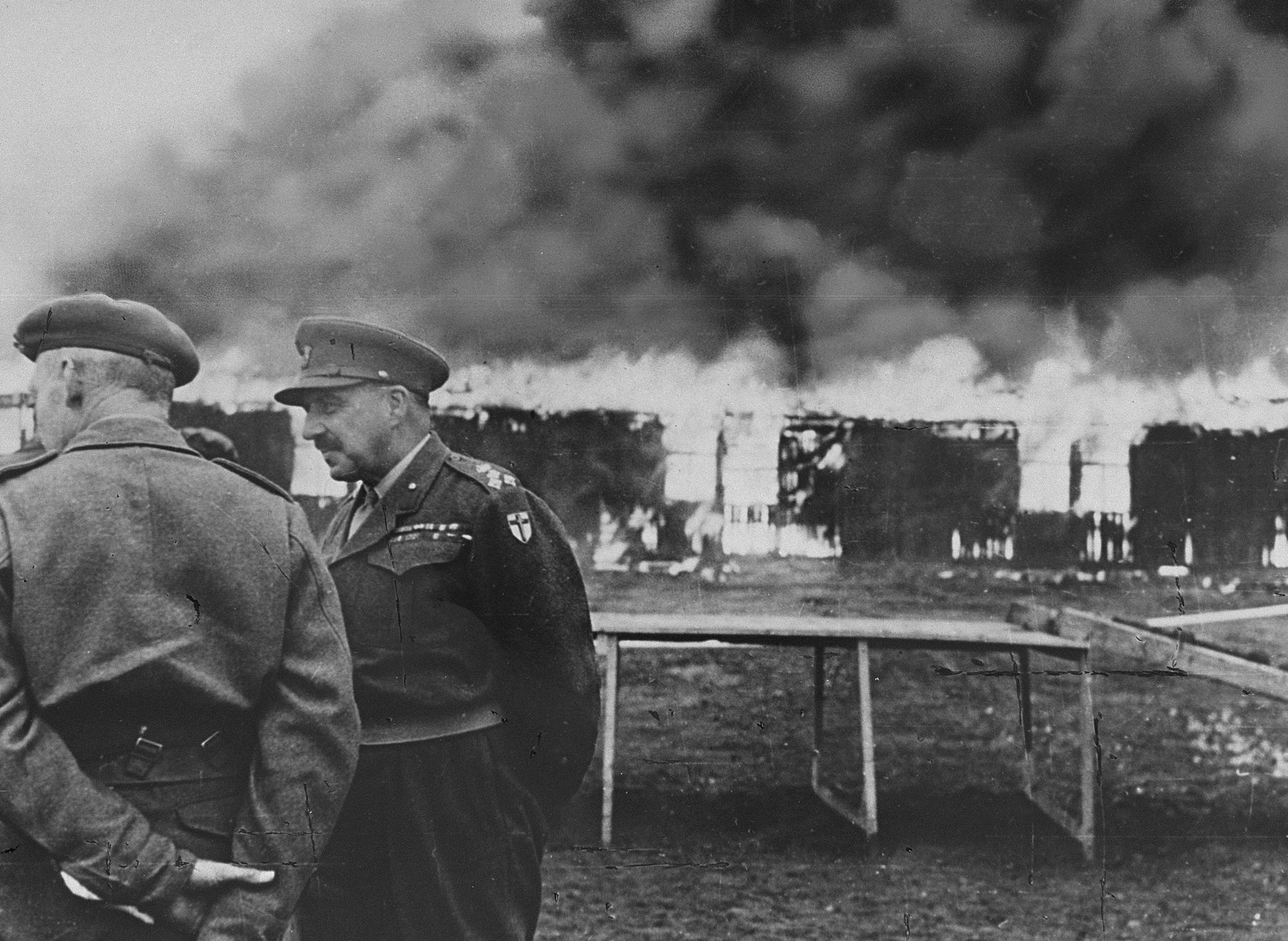 British officers stand outside camp no. 1 of Bergen-Belsen at the time of its destruction.