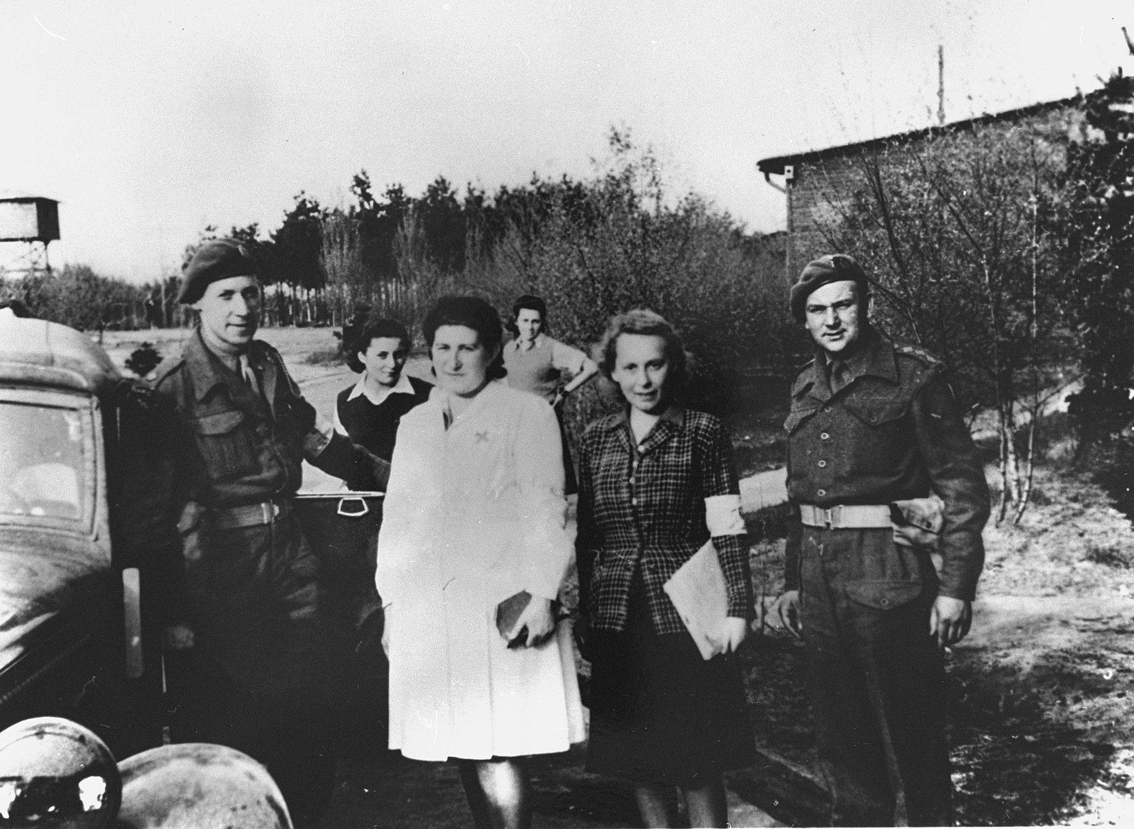 Survivors pose with British soldiers soon after the liberation of Bergen-Belsen.

Among those pictured is Hadassah Bimko (second from the left), Captain Winterbottom, and Dr. Ruth Gutman.