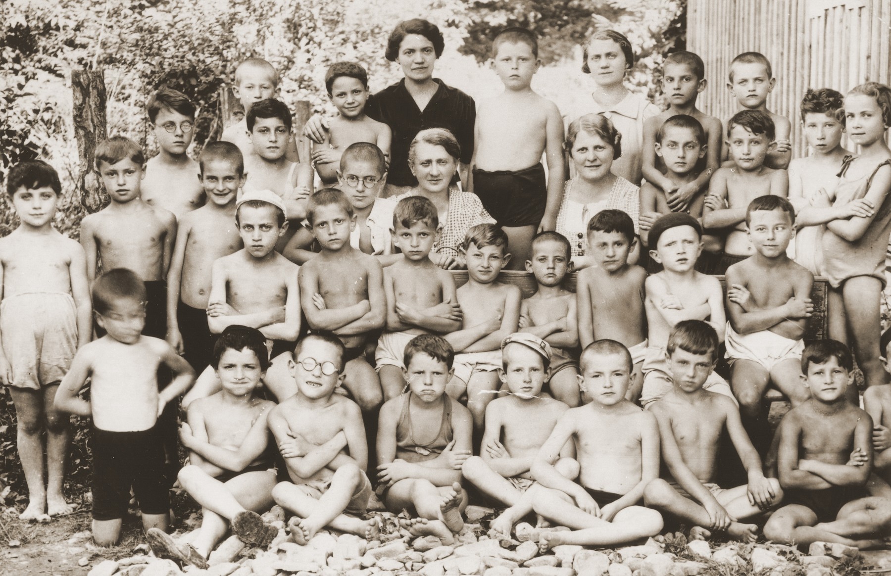 Group portrait of Jewish children at an OSE summer camp.   

Among those pictured are Anny (Hubner) Andermann (third row, fifth from the right); OSE pediatrician, Dr. Salter (next to Anny); and her son, Frederick Andermann (standing between the two women).
