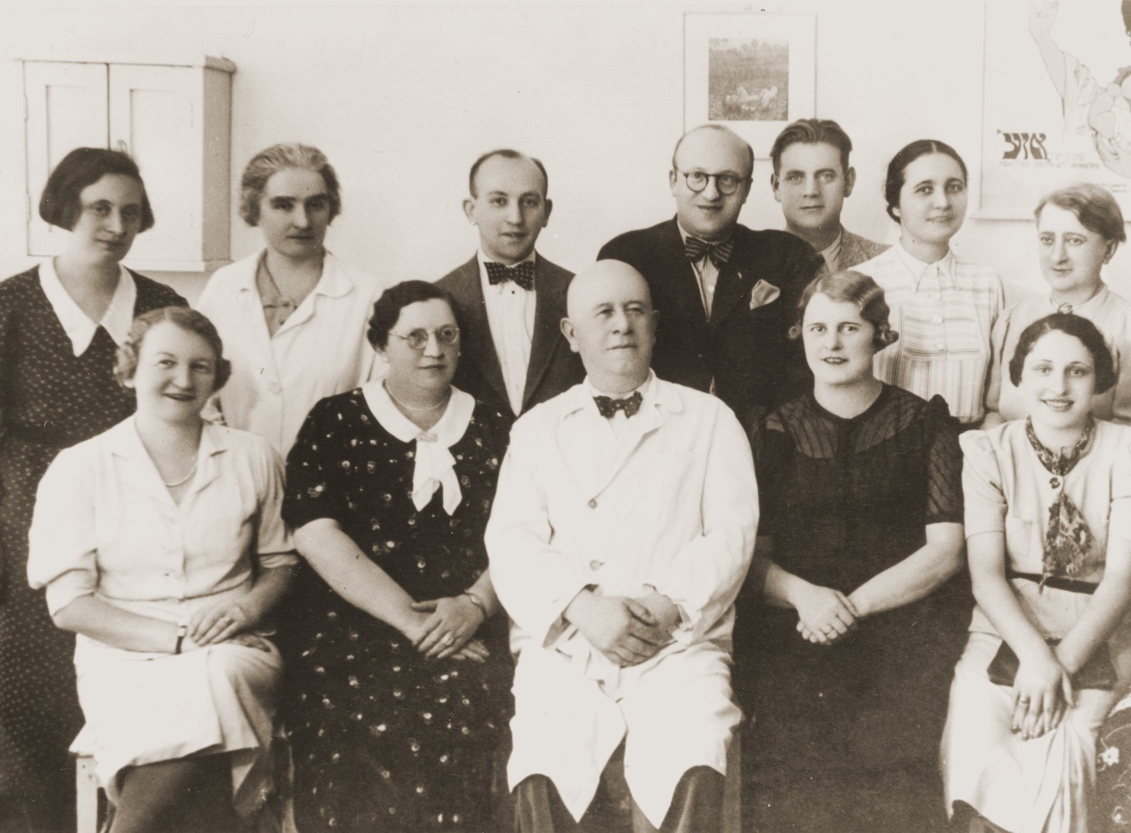 Group portrait of the staff and administrators of the OSE children's clinic in Cernauti, Romania.  

Among those pictured are Dr. Noe (front row center); Anny (Hubner) Andermann (front row, second from the right); Dr. Mendel Wiesenthal (standing in the back row, fourth from the right); and Dr. Salter (back row, far right).
