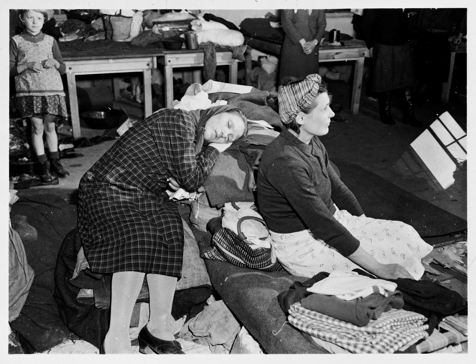 Female survivors rest in the Ernst Leitz Optical works in Wetzlar after their liberation by American troops with the First Army.  

These workers from Poland and the Ukraine were captives for the past three years.  They worked from 5am to 6pm daily, and were fed a steady diet of beet soup and black bread.