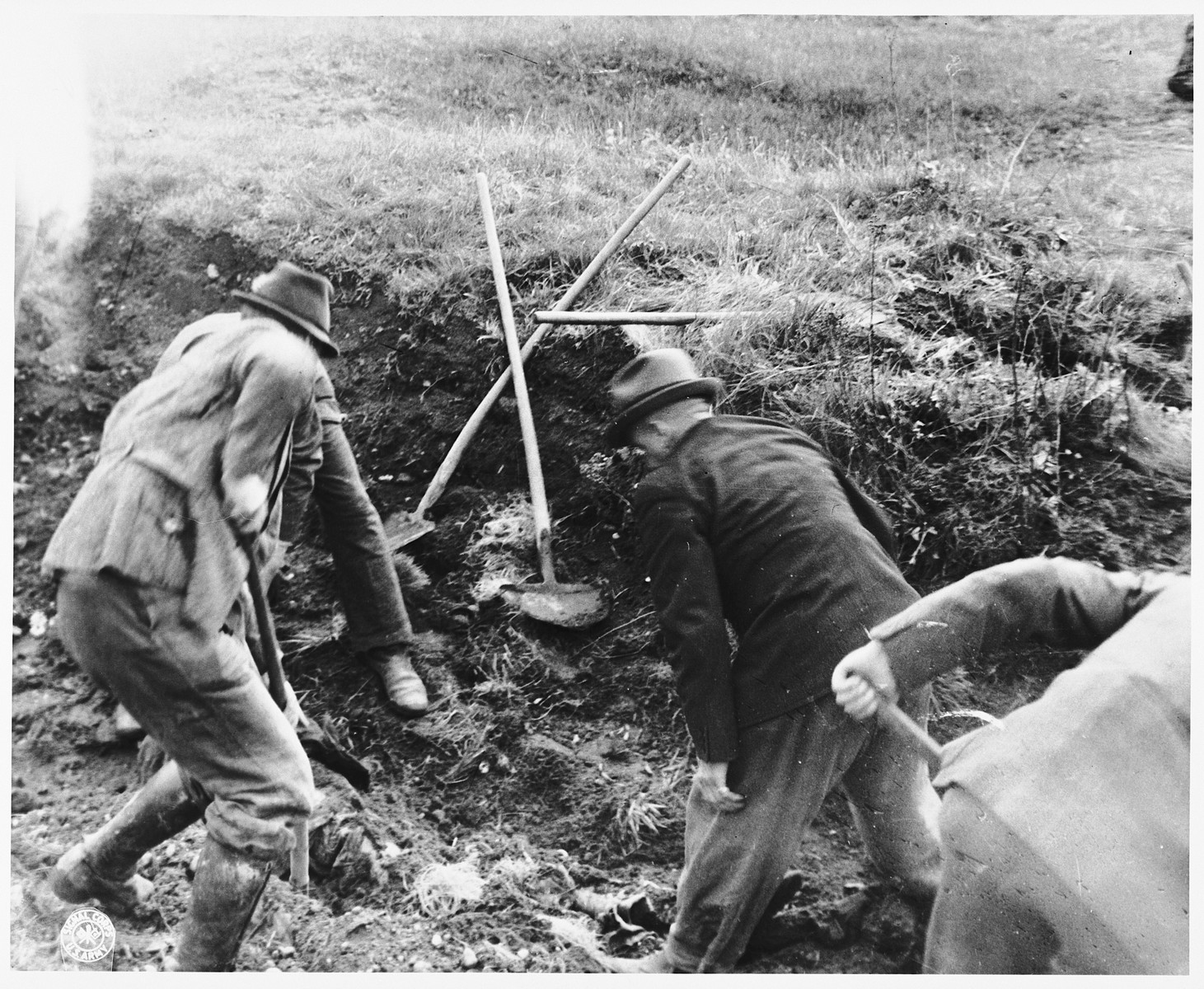 German civilians from Schwarzenfeld exhume the bodies of 140 Hungarian, Russian, and Polish Jews from a mass grave near the town.  

The victims died while on an evacuation transport from the Flossenbuerg concentration camp.