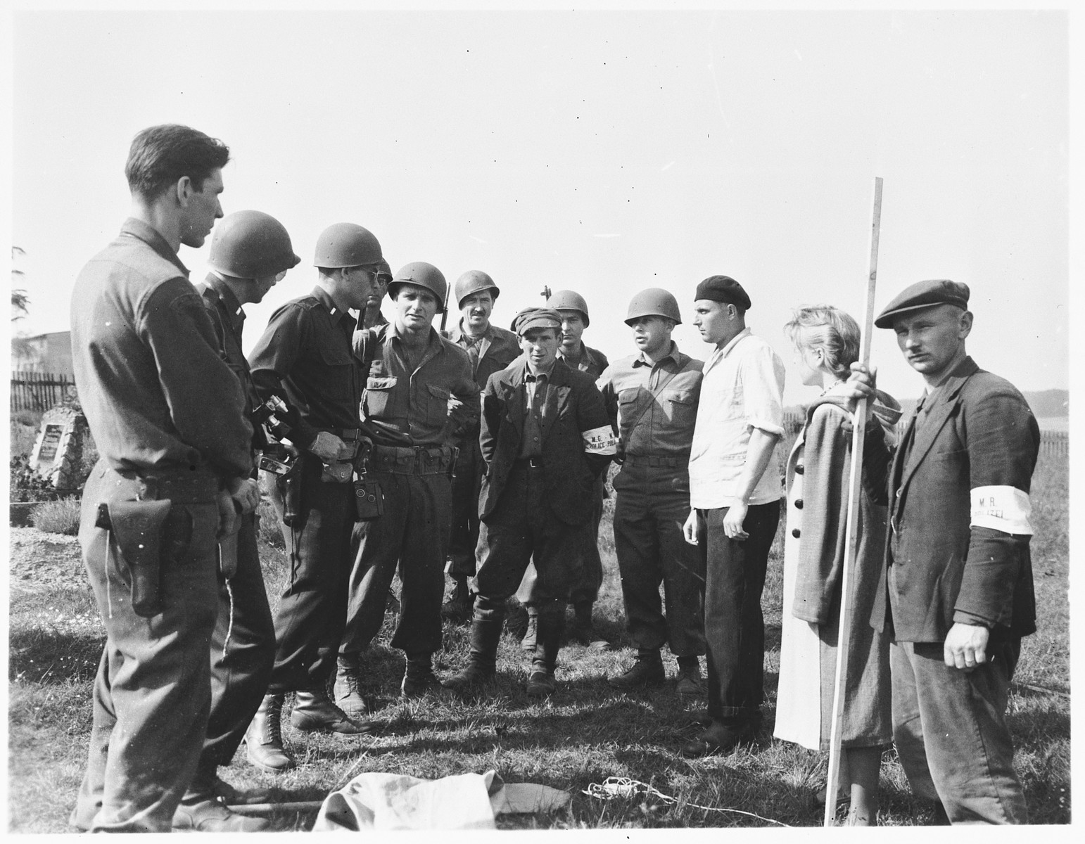American military authorities question a German civilian from Estedt (pictured third from right) about the atrocity that occurred near the town.